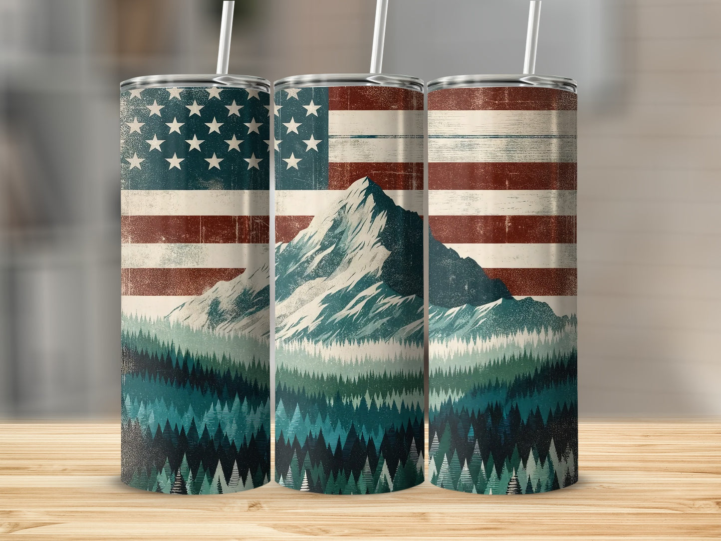 American flag over a mountain and pine forest scene on three tumblers.