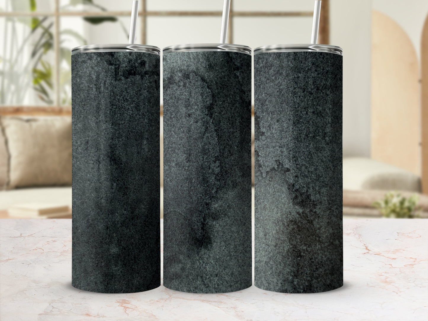 Three tumblers with a dark, textured pattern displayed on a marble surface.