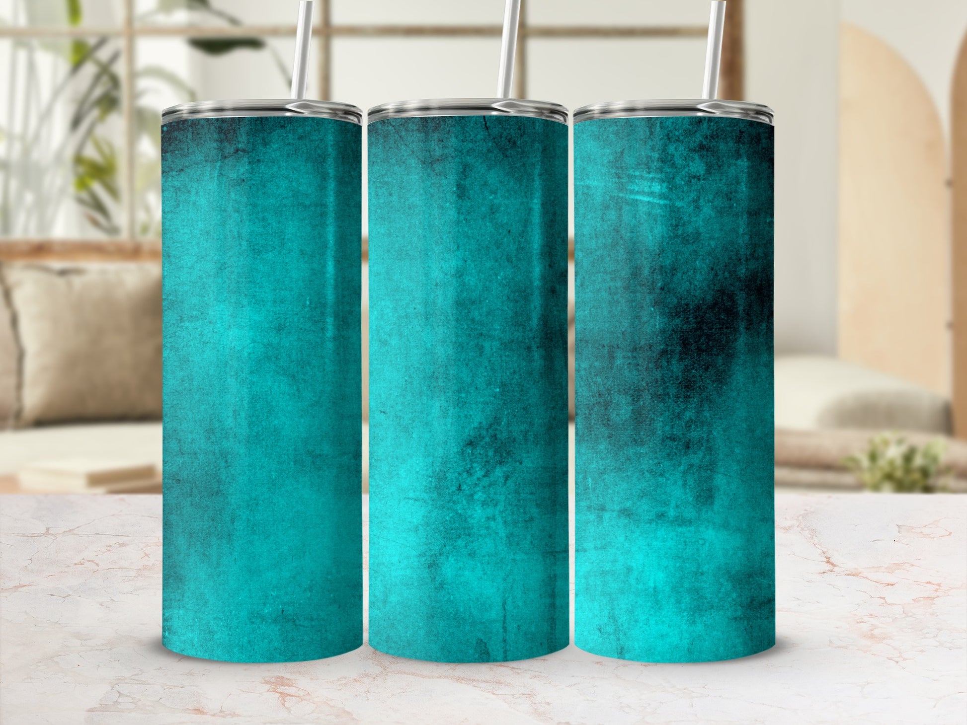 Three teal textured tumblers with silver lids and straws against a blurred background.