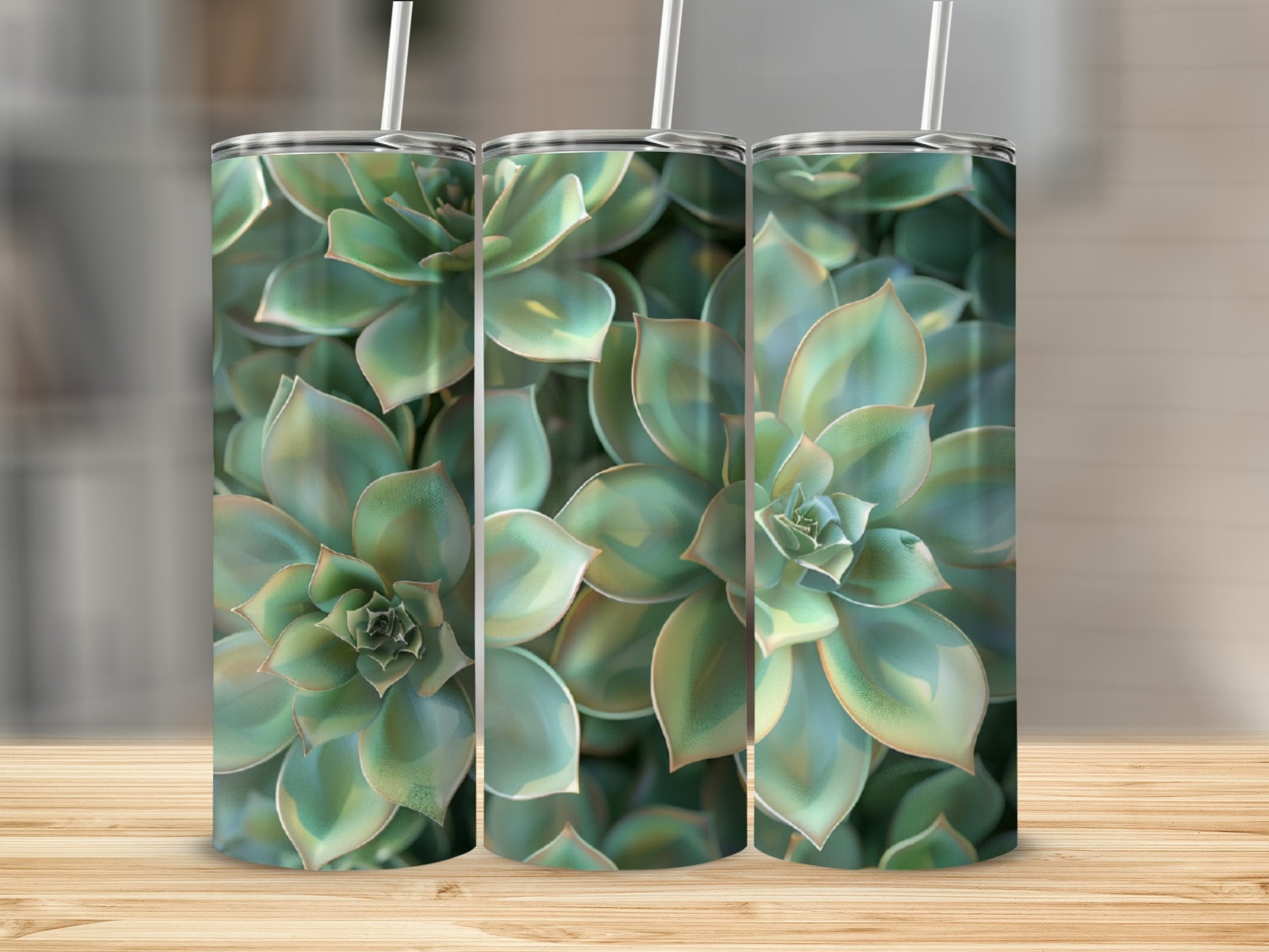 Three tumblers with succulent plant pattern on a wooden surface.