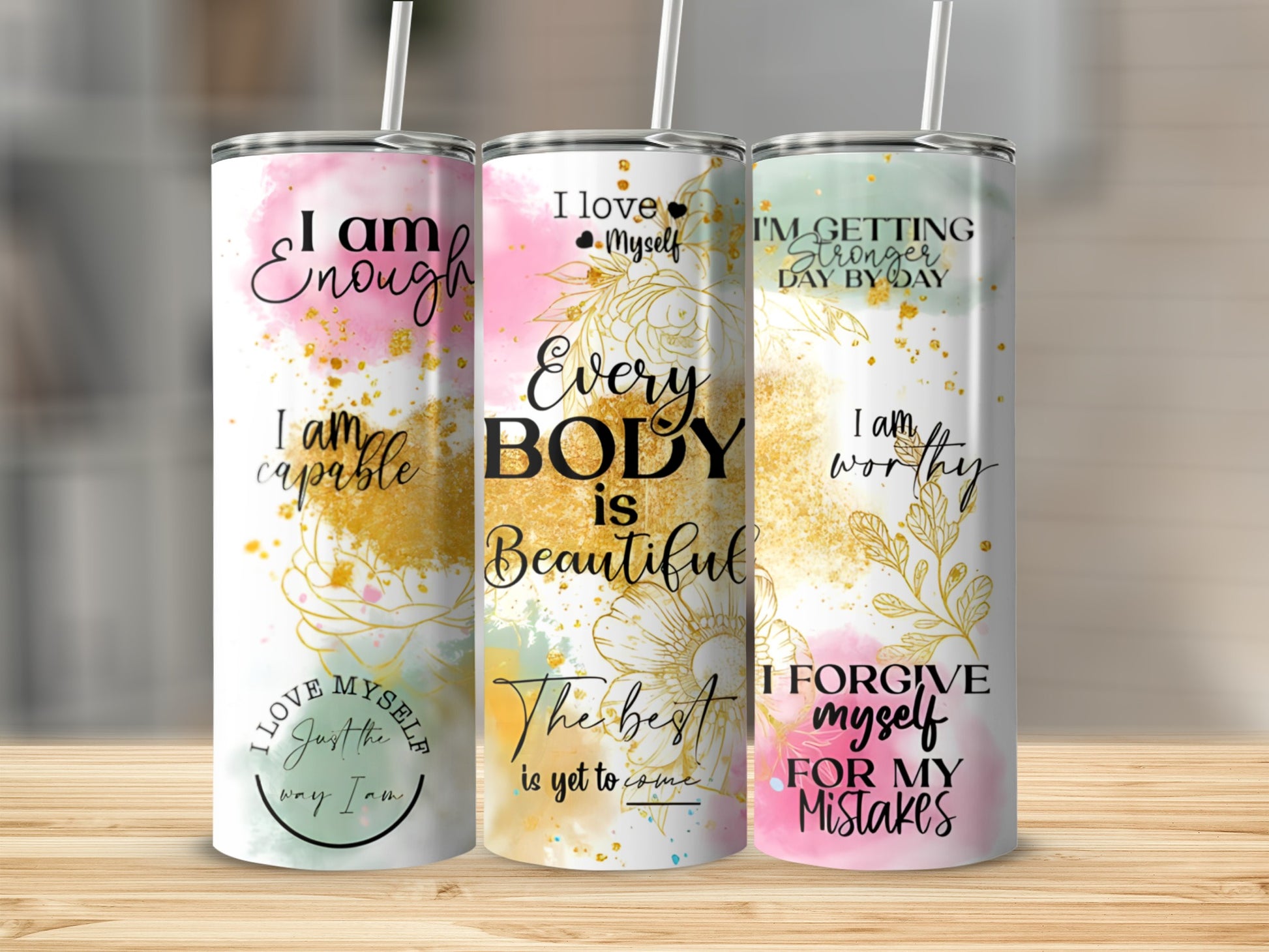 Three tumblers with empowering phrases about self-love and worth.