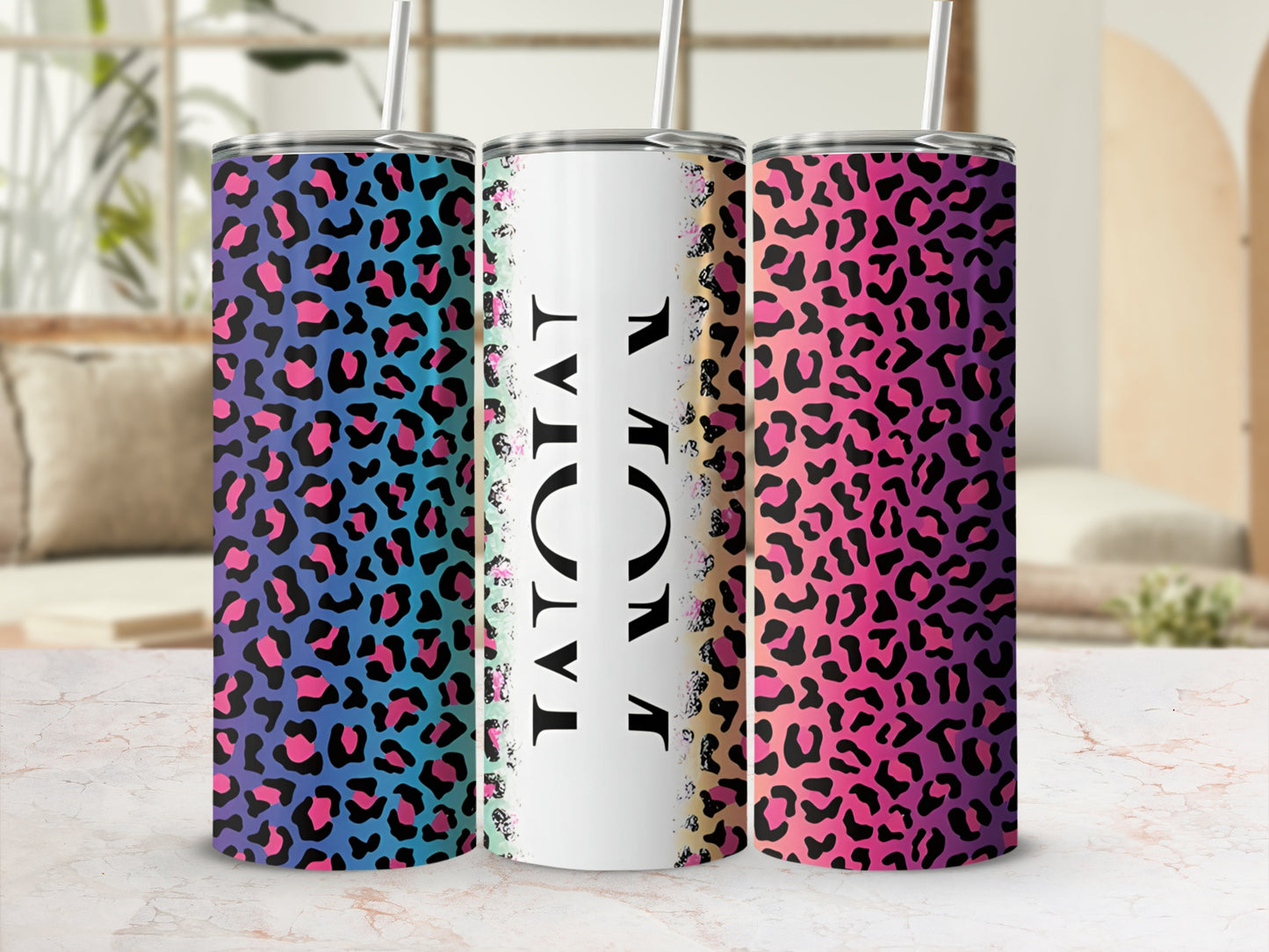 Three tumblers with leopard print in pink, purple, blue, and teal.