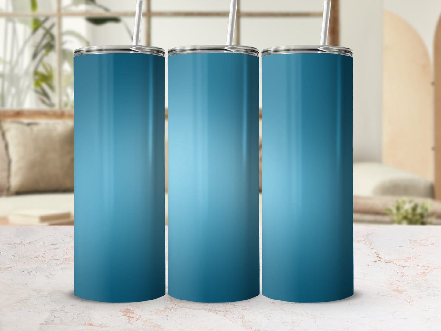 Three tall blue tumblers with straws stand on a marbled surface.