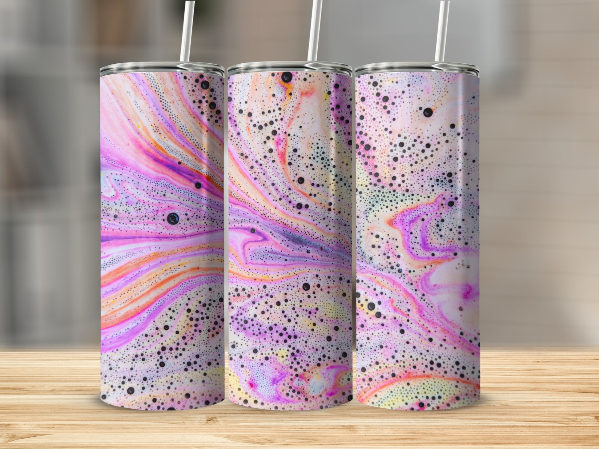 Three tumblers with a colorful marbled and bubbly pattern.