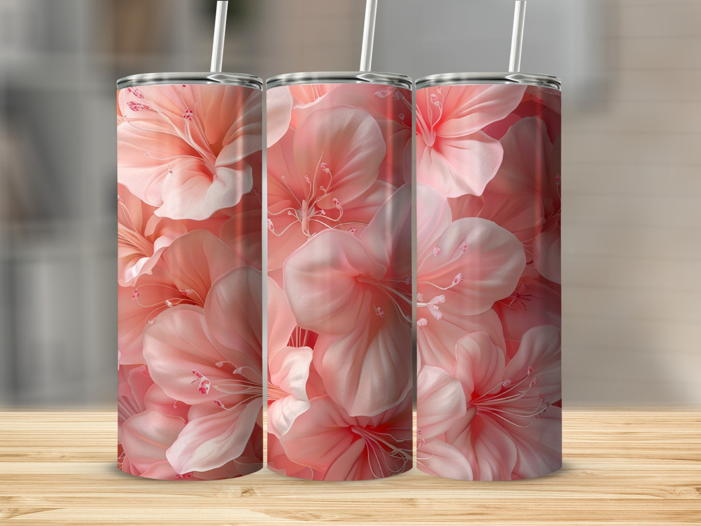 Three tumblers with a light pink floral design on a wooden surface.