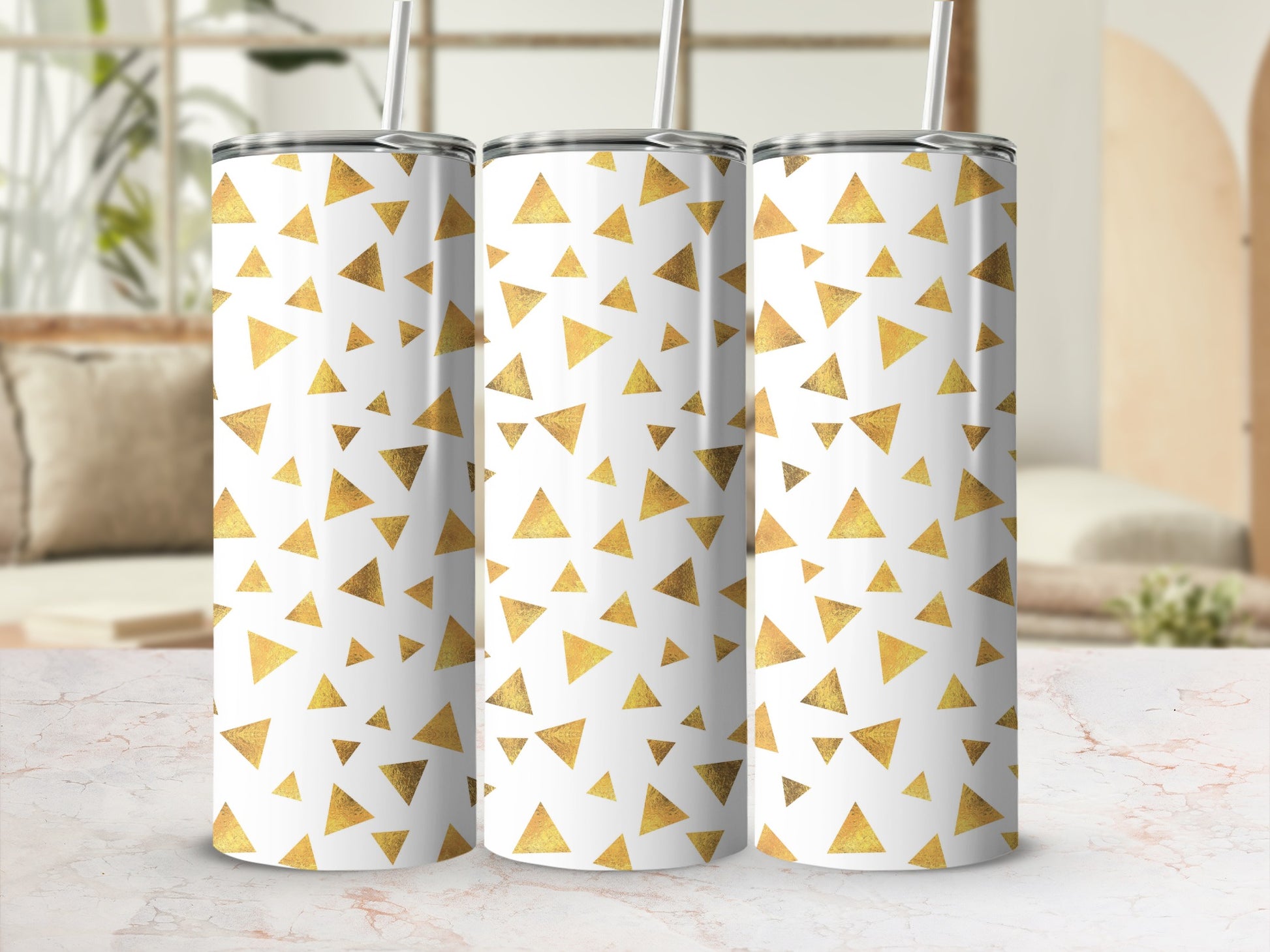 Three tumblers with a white surface and a gold geometric triangle pattern.