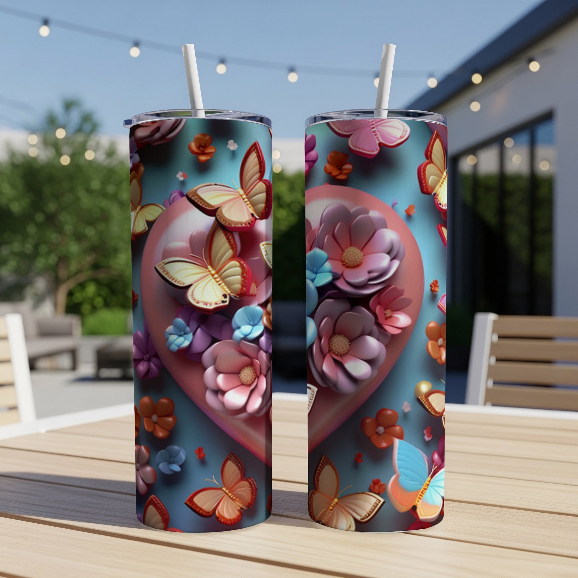 Two tumblers with butterflies and pink flowers on a blue background.