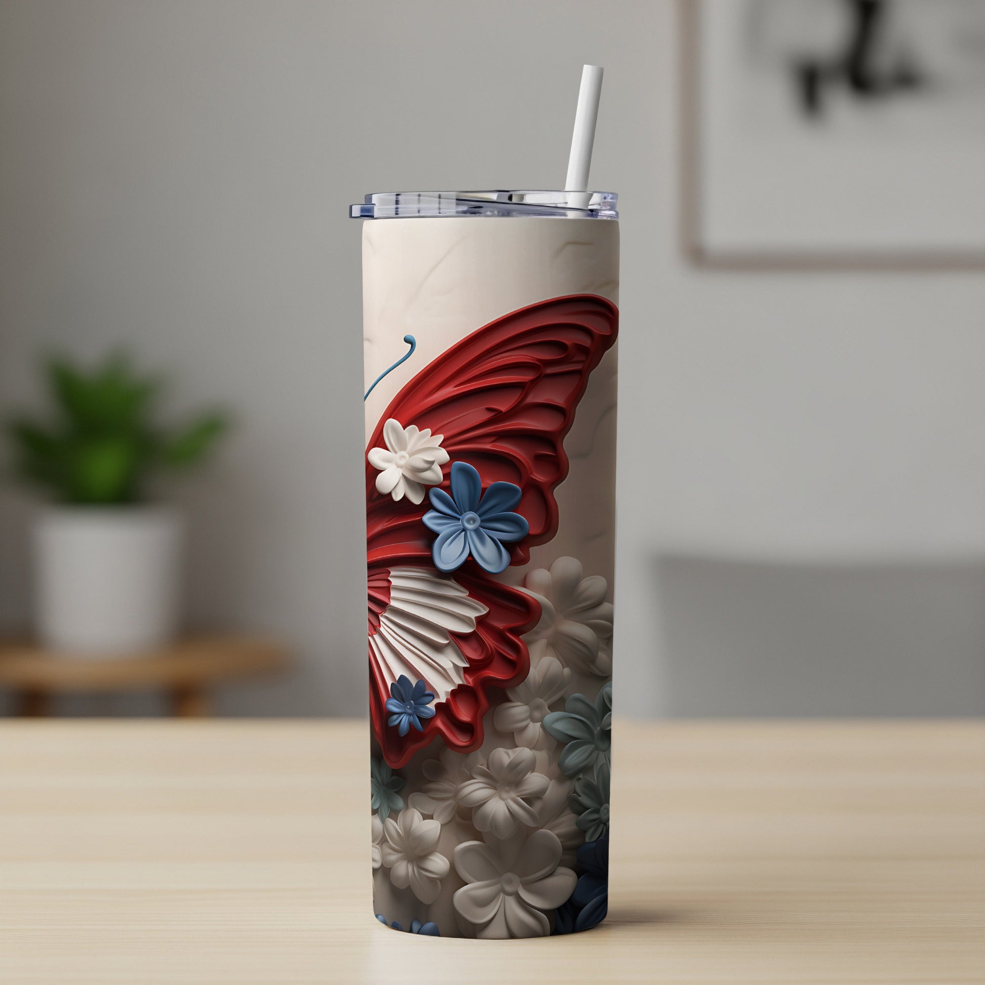 Red, white, and blue butterfly and floral tumbler with straw.