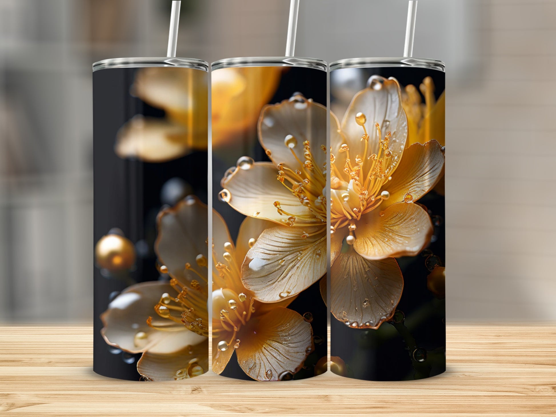 Three tumblers with golden flowers and water droplets.