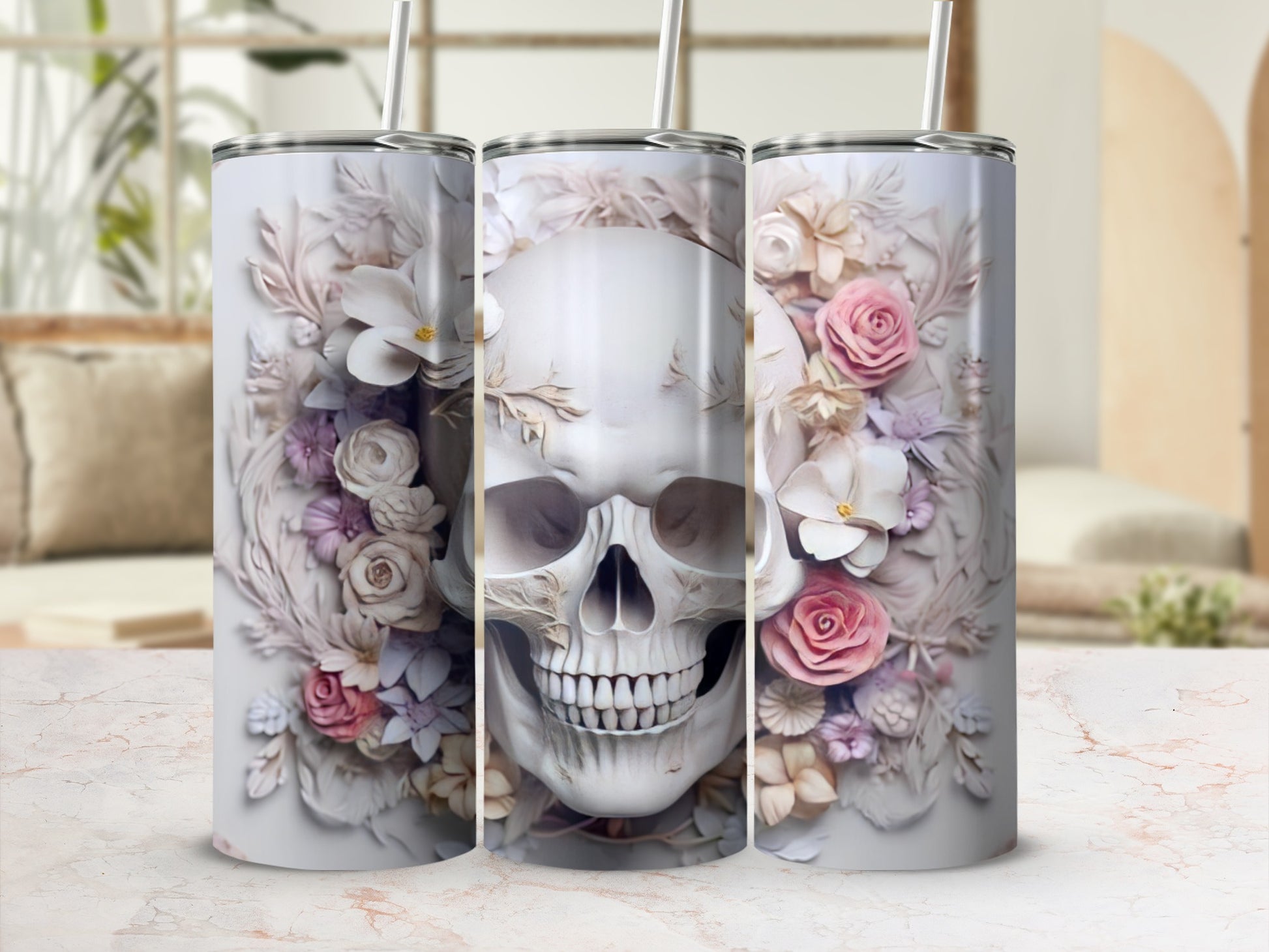 Three white tumblers with floral skull design on marble surface.