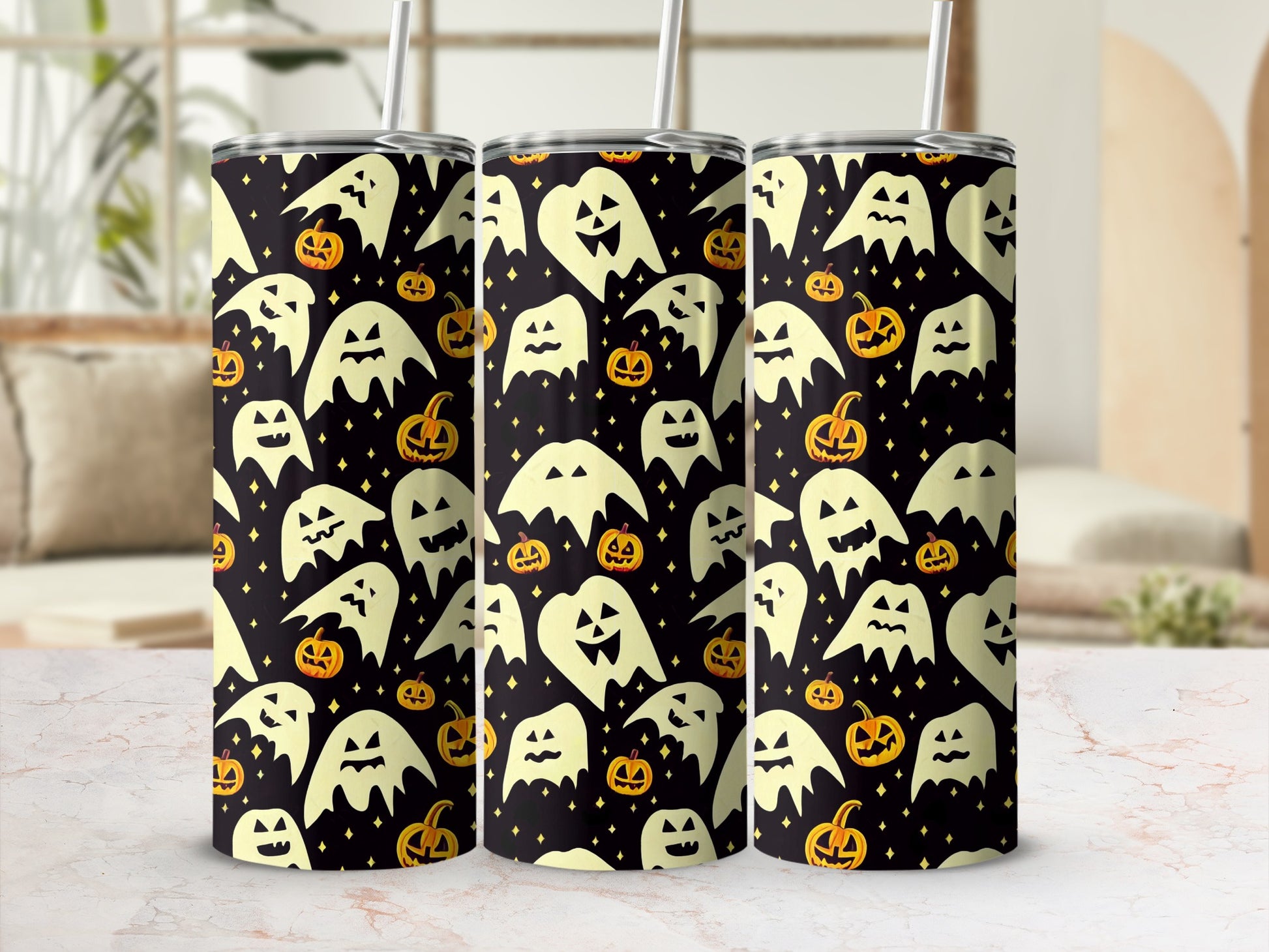 Three tumblers with a black background featuring a pattern of cream-colored ghosts and jack-o'-lanterns.