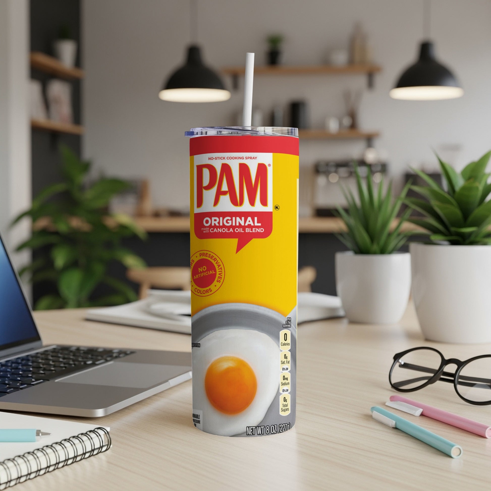 Pam Original No-Stick Cooking Spray can on a desk with a laptop and supplies.