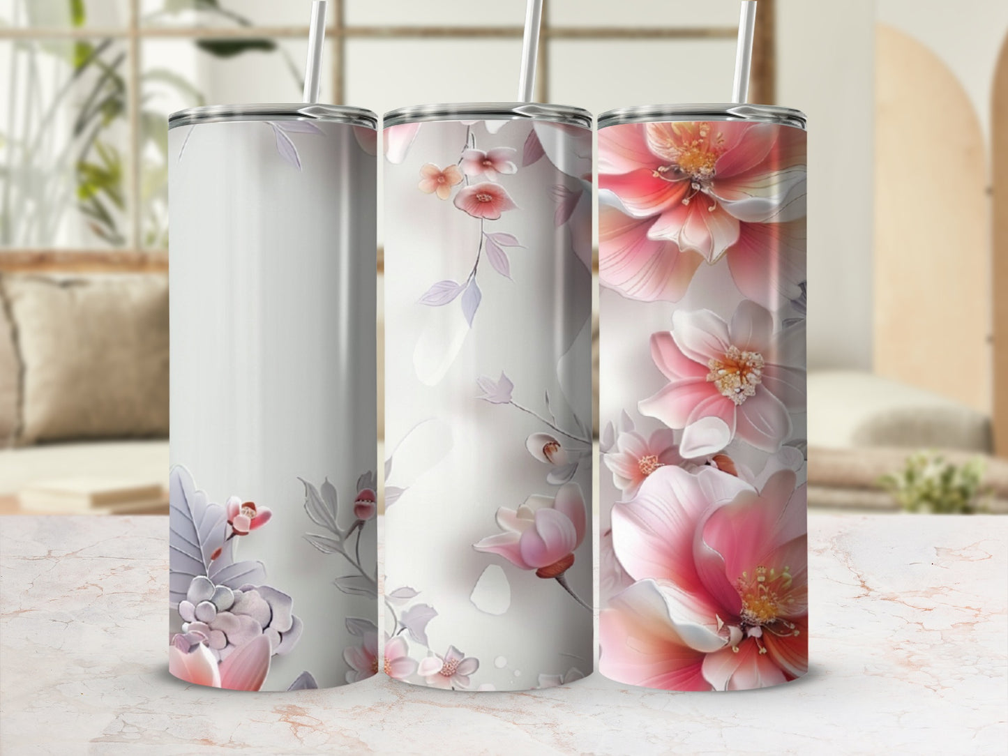 Three tumblers with delicate floral designs, one blank, two with pink and purple flowers.