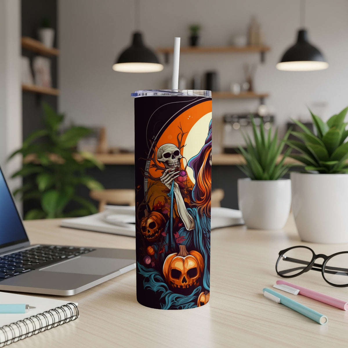 Halloween tumbler with skeleton, witch, and pumpkins artwork.