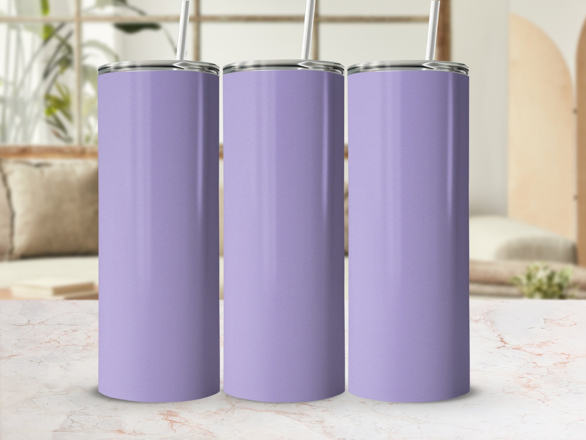 Three plain purple tumblers with straws displayed on a marble surface.
