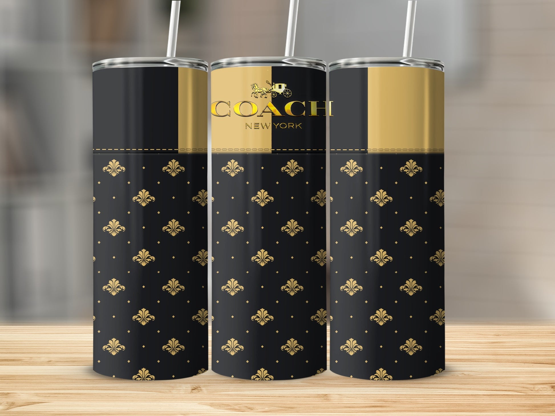 Three black and gold Coach New York tumblers with fleur-de-lis pattern.