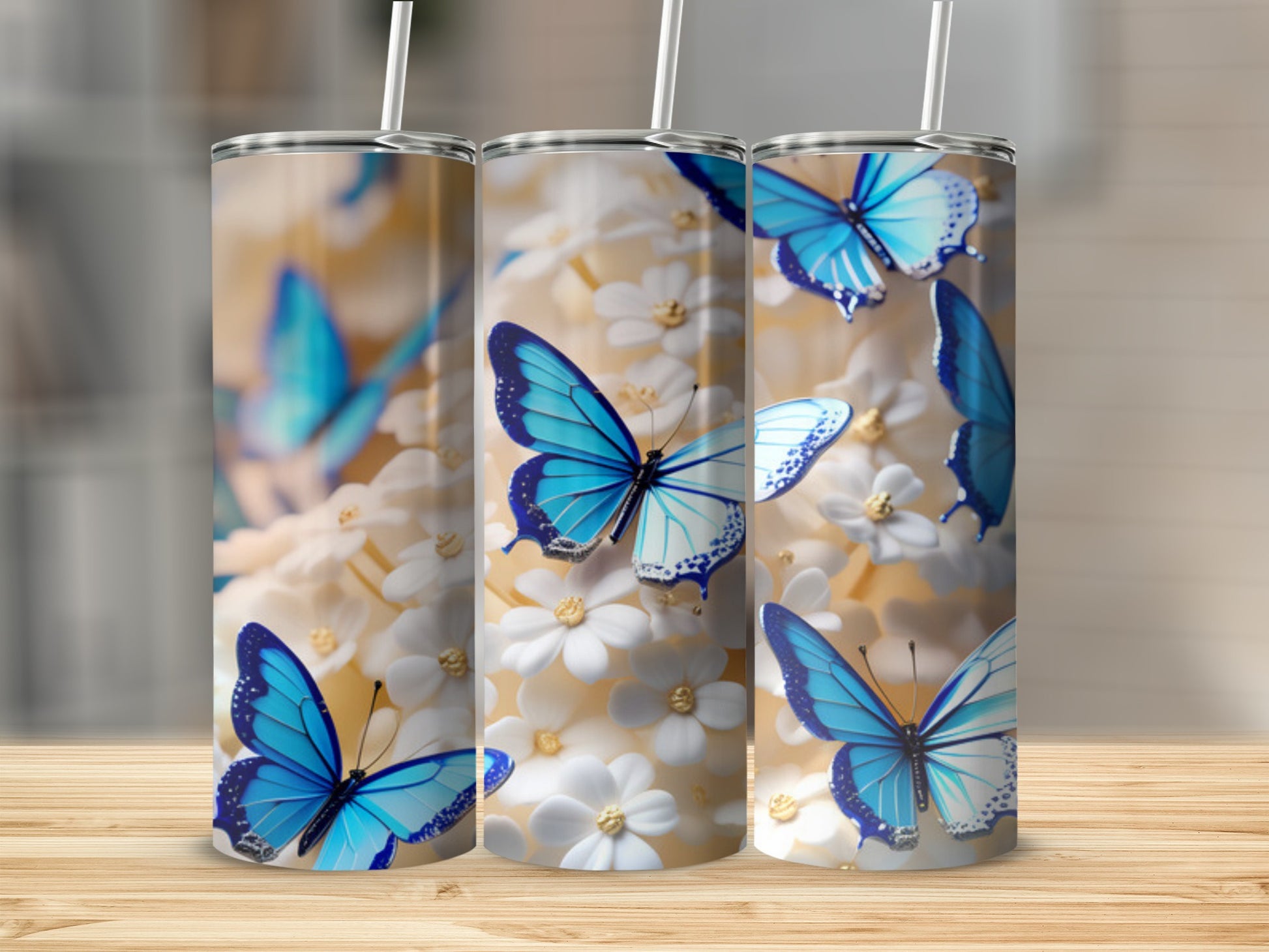 Three tumblers with blue butterflies and white flowers design.