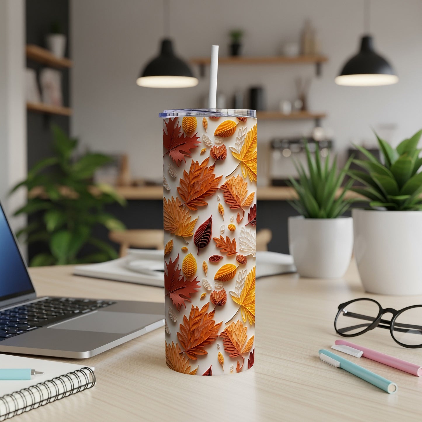 White tumbler with a repeating pattern of colorful autumn leaves.