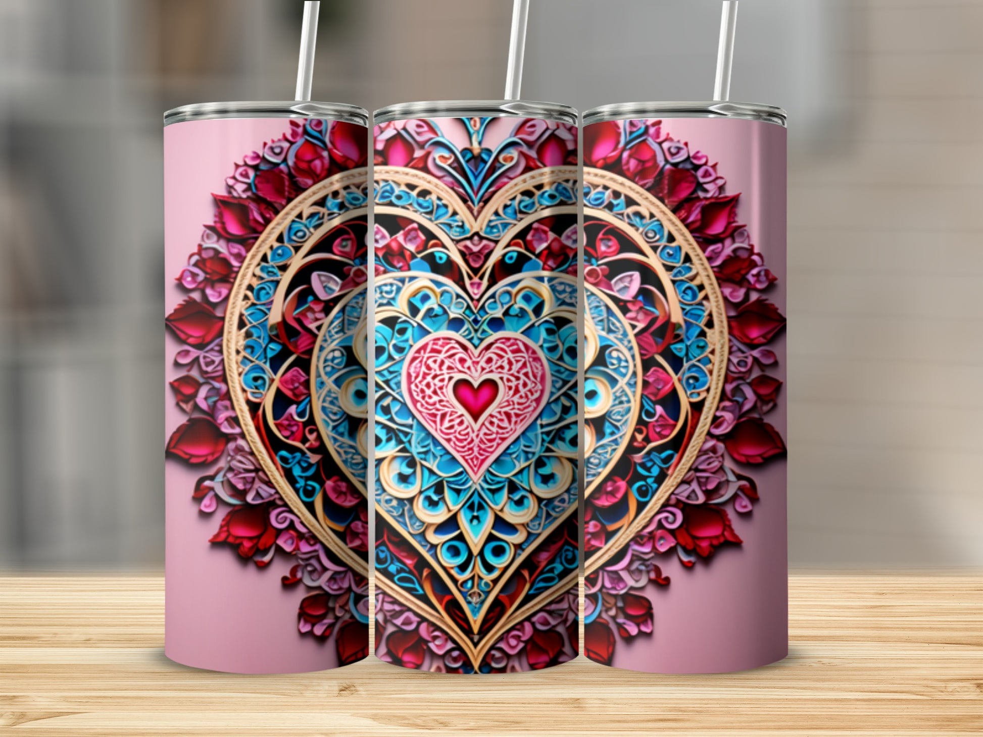 Three pink tumblers with colorful mandala heart designs on a pink background.