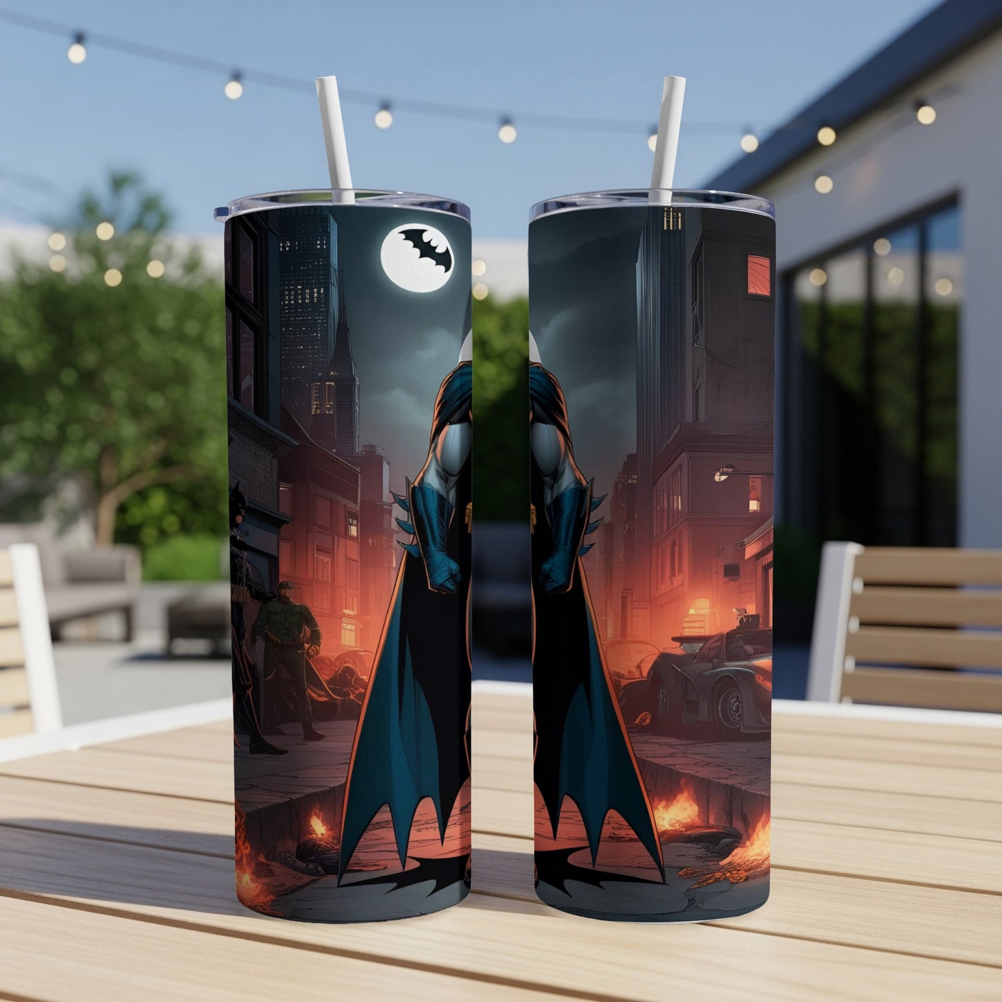 Batman art on two tumblers with city background and streetlights.