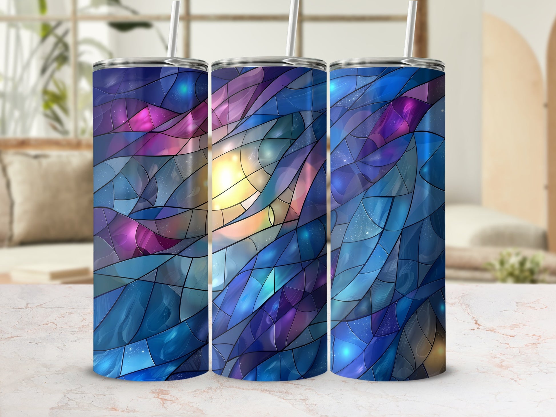 Three tumblers with a colorful, stained-glass, celestial pattern.