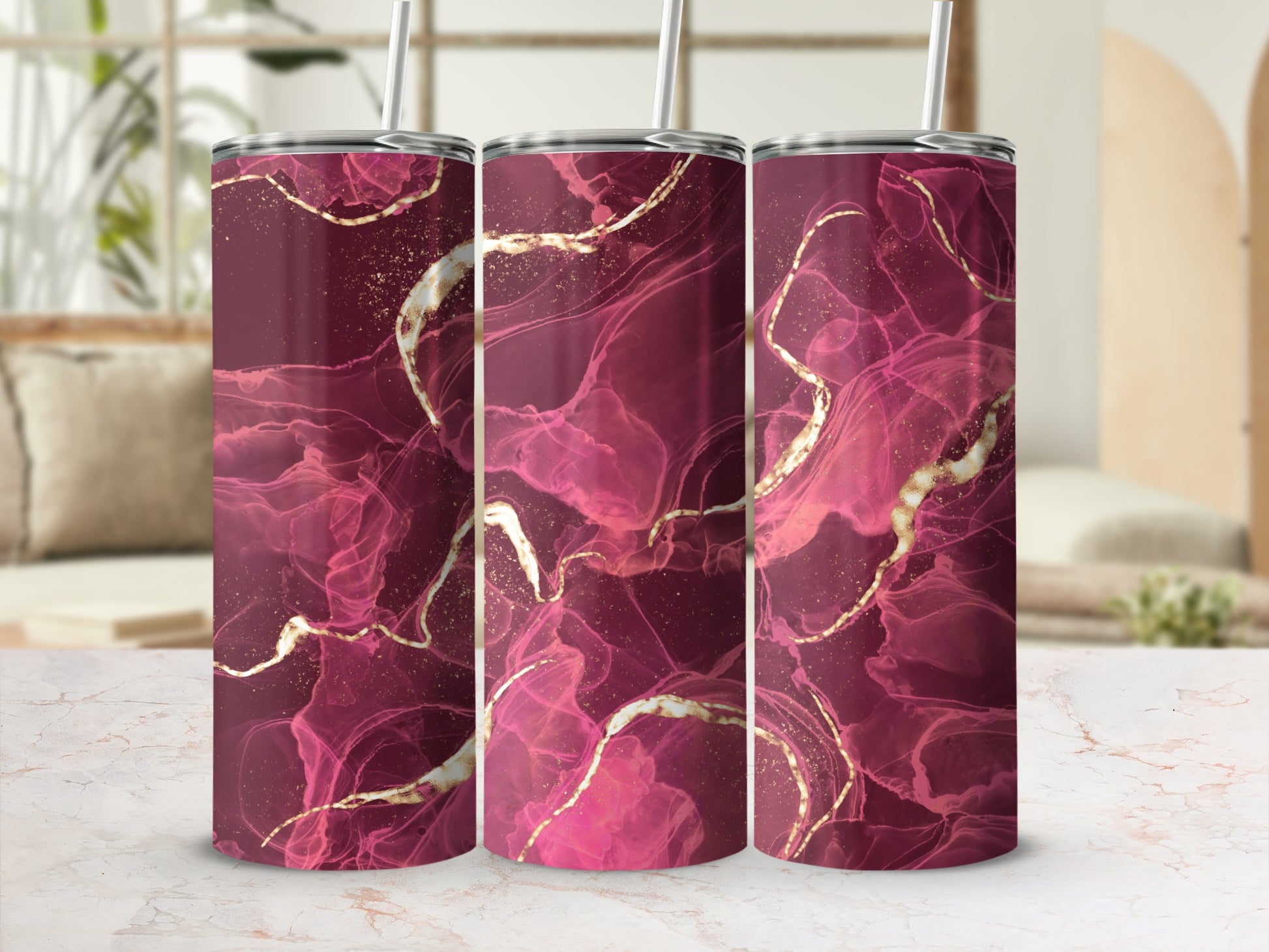 Three tumblers with a dark pink and gold marble-like design.