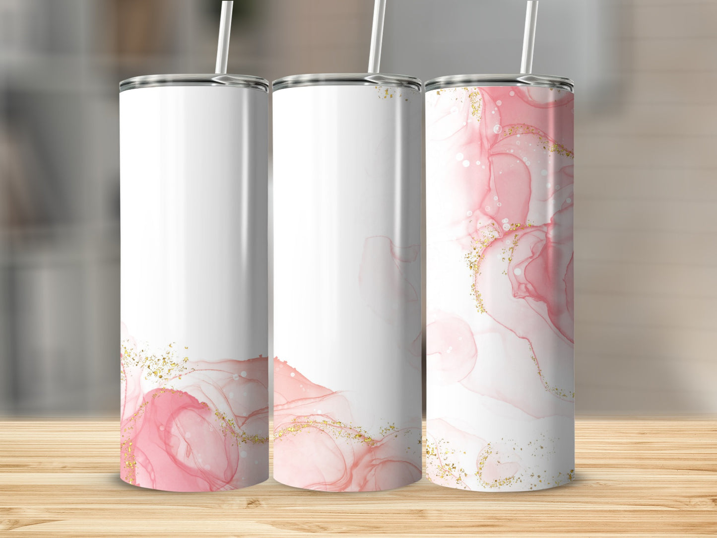Three white tumblers with pink watercolor designs and gold glitter accents.