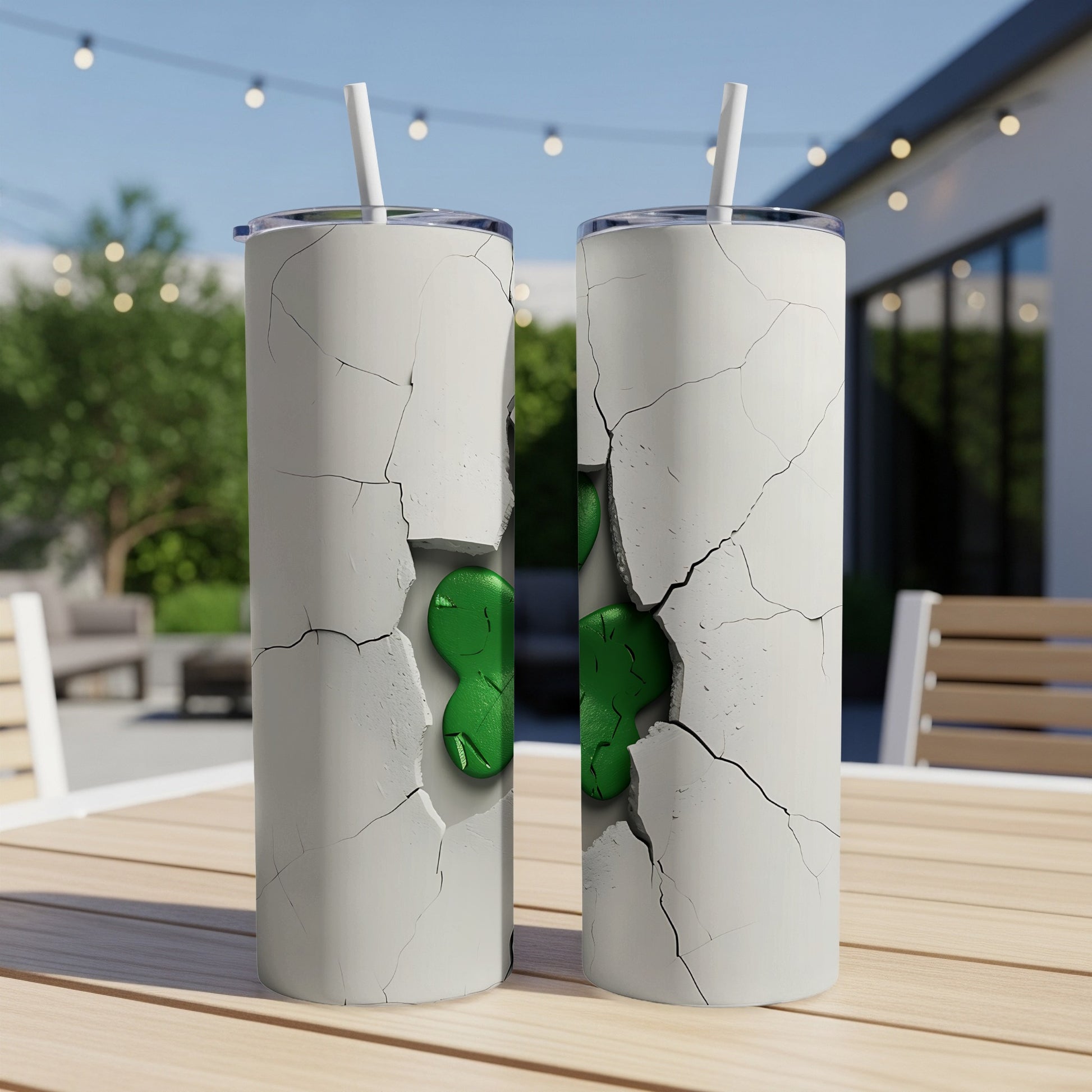 Two white tumblers with cracked concrete design and green shamrocks.