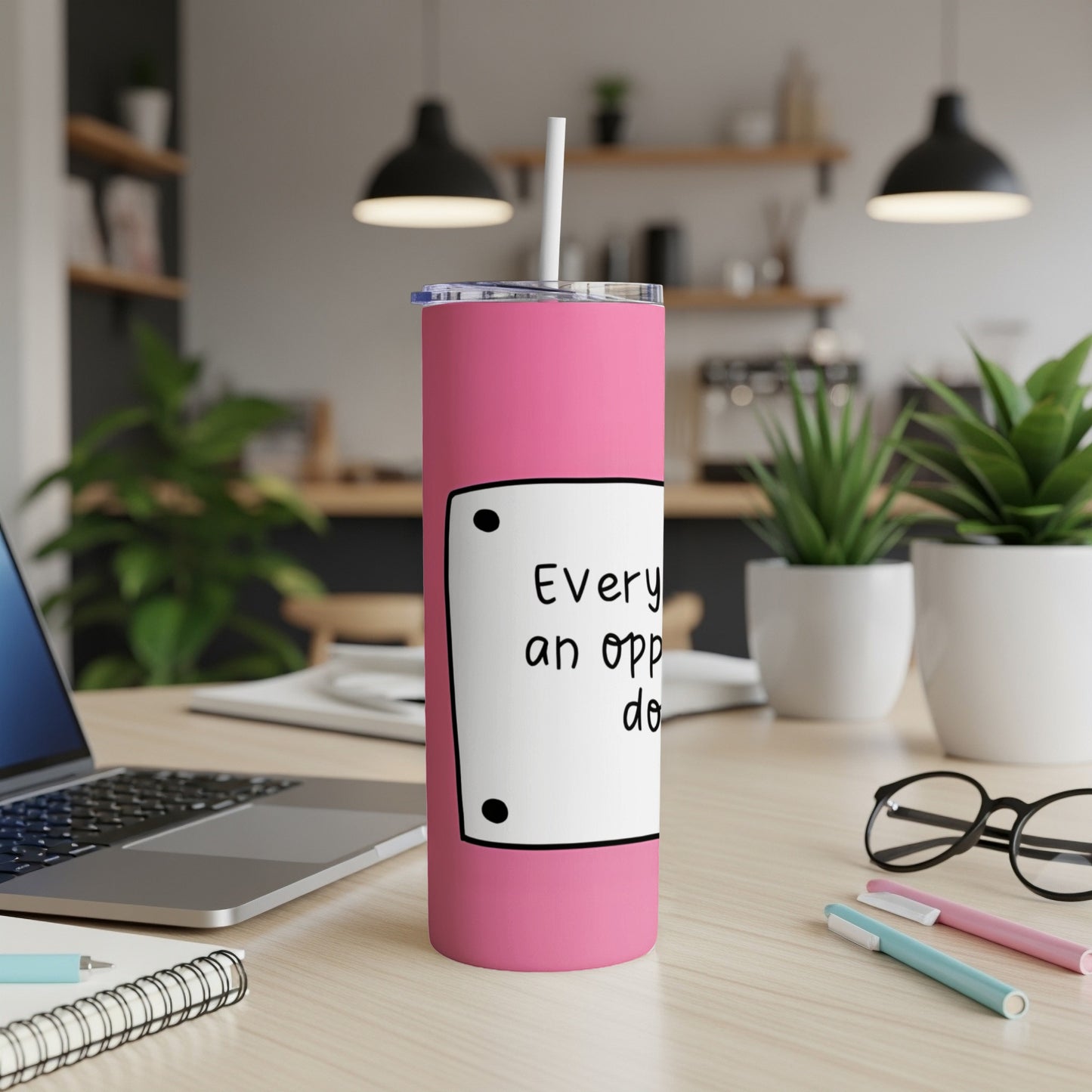 Pink tumbler with text "Every day an opportunity" and a straw.
