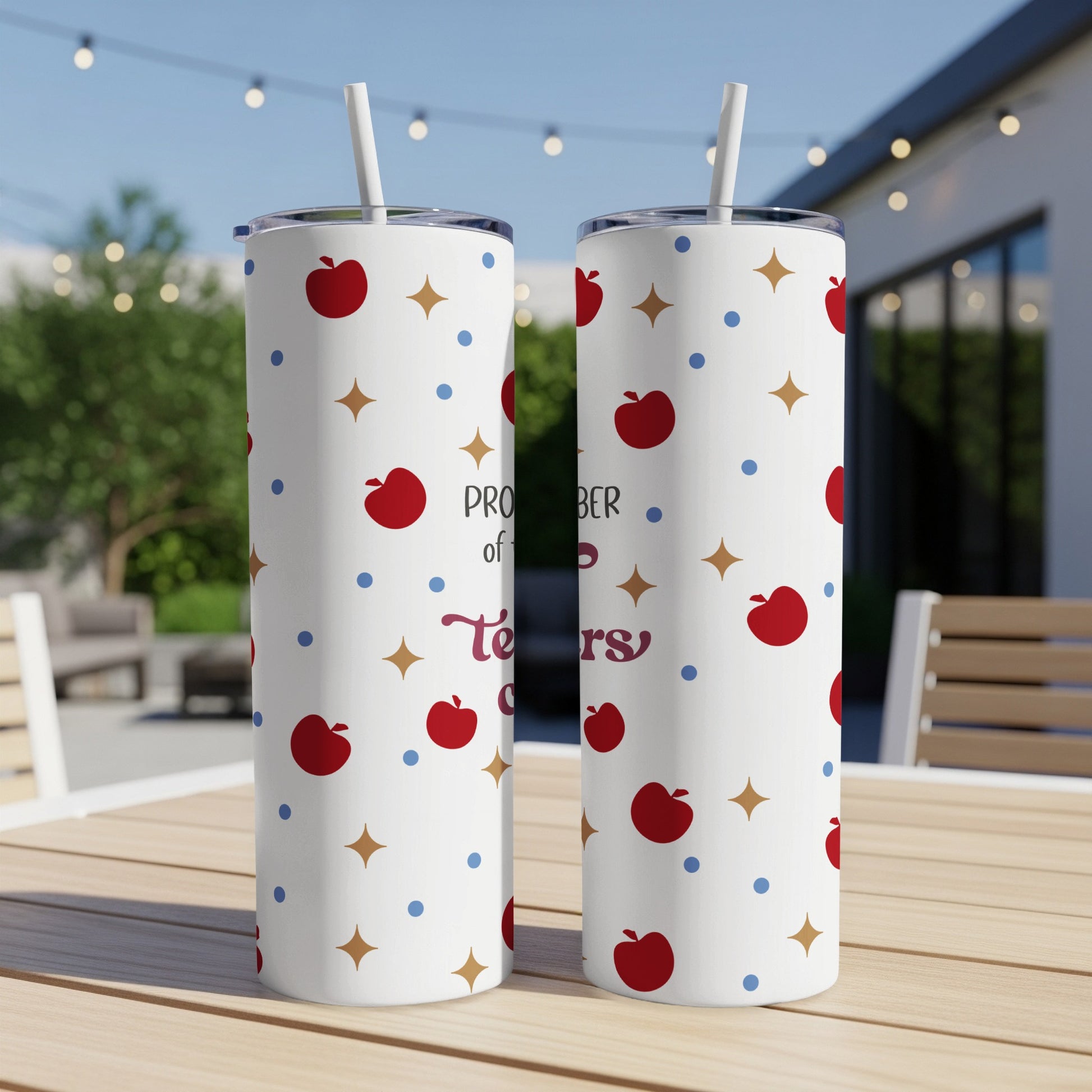 White tumbler with apple and star pattern, "Proud Teacher" text.