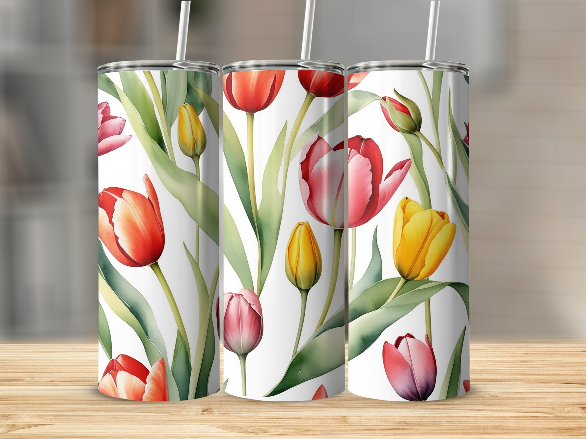 Tall tumblers with a watercolor tulip pattern in red, pink, and yellow.