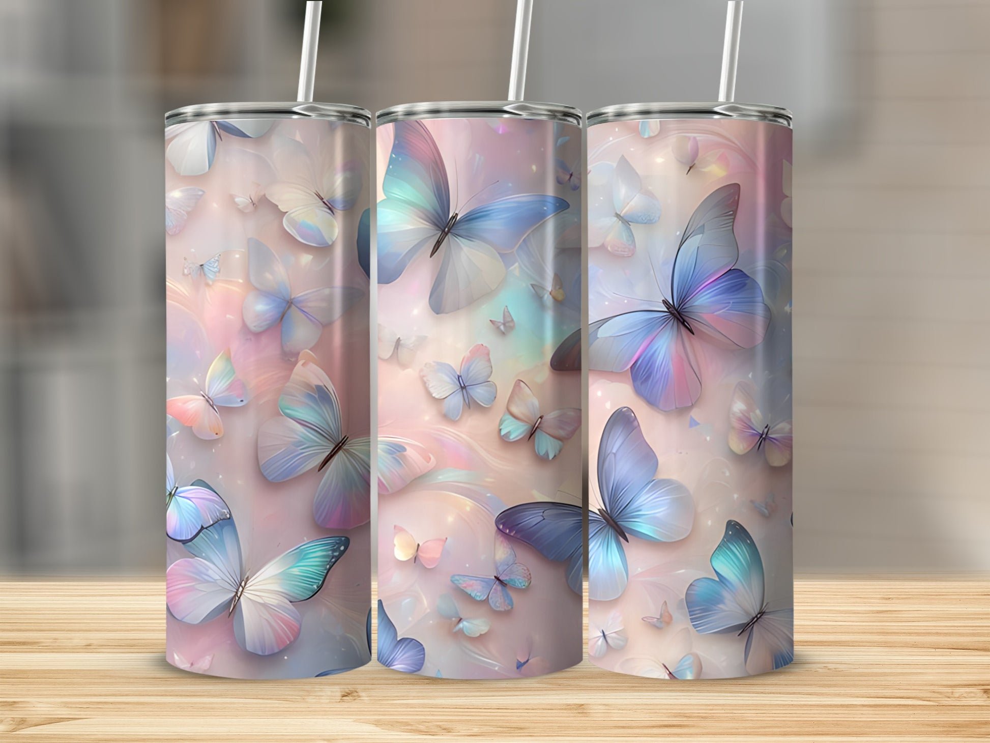 Three tumblers adorned with pastel butterflies and swirling colorful accents.