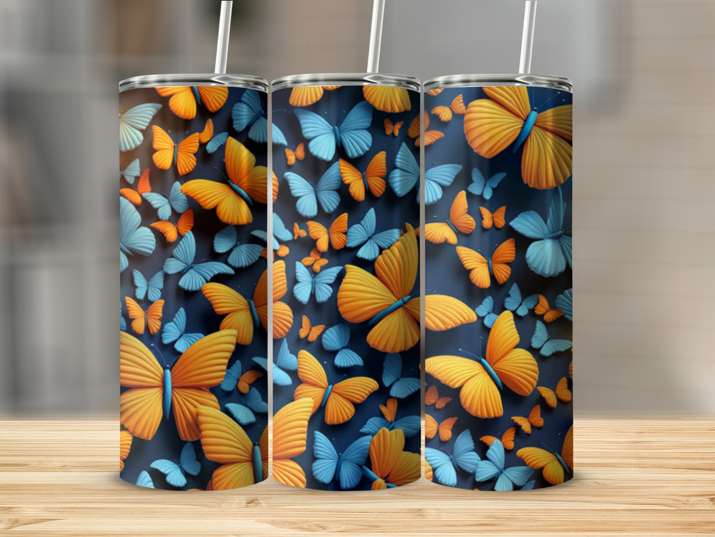 Three tumblers with vibrant orange and blue butterfly patterns.