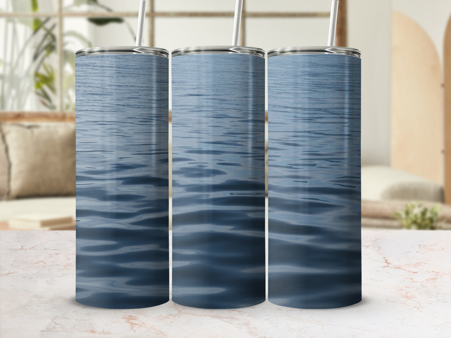 Three tumblers with a close-up view of rippling blue water.