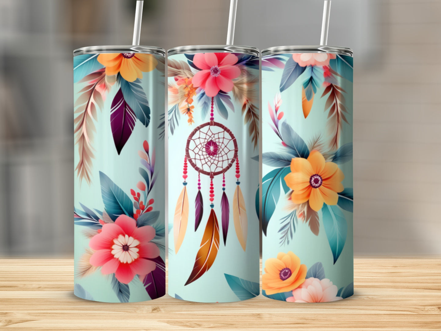 Three tumblers with floral and dreamcatcher designs on a light blue background.