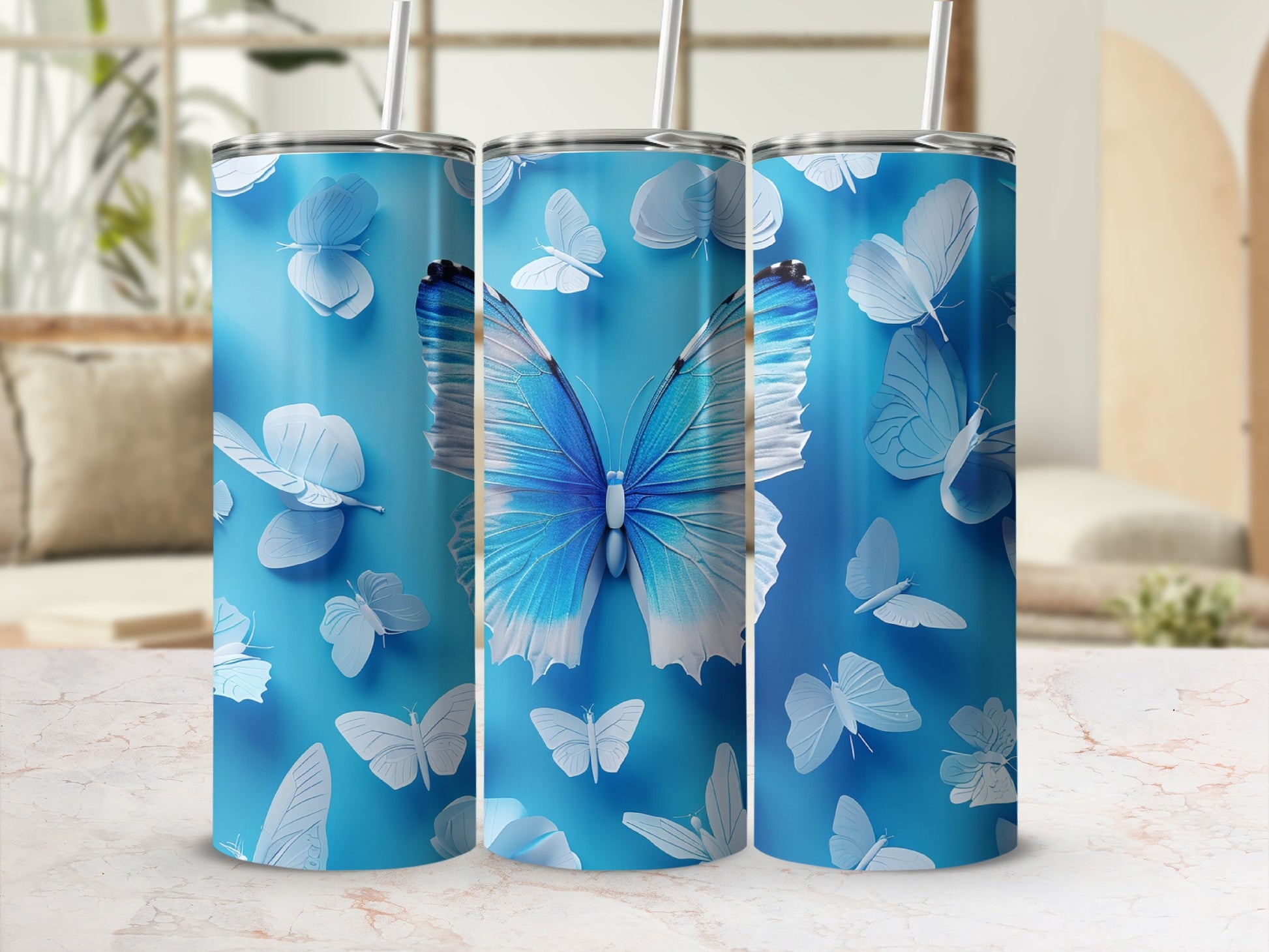 Blue tumbler with white and blue butterflies and a central large blue butterfly.