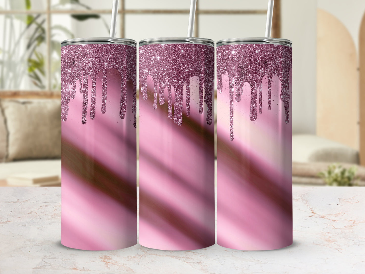 Three pink glitter drip tumblers with straws on a marble surface.