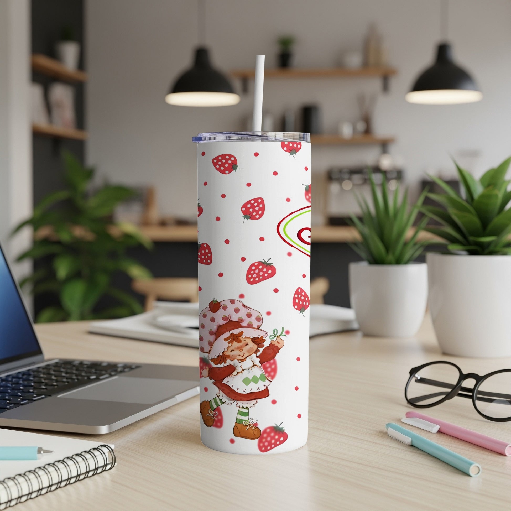 Strawberry Shortcake character on a white tumbler with strawberries and green accents.