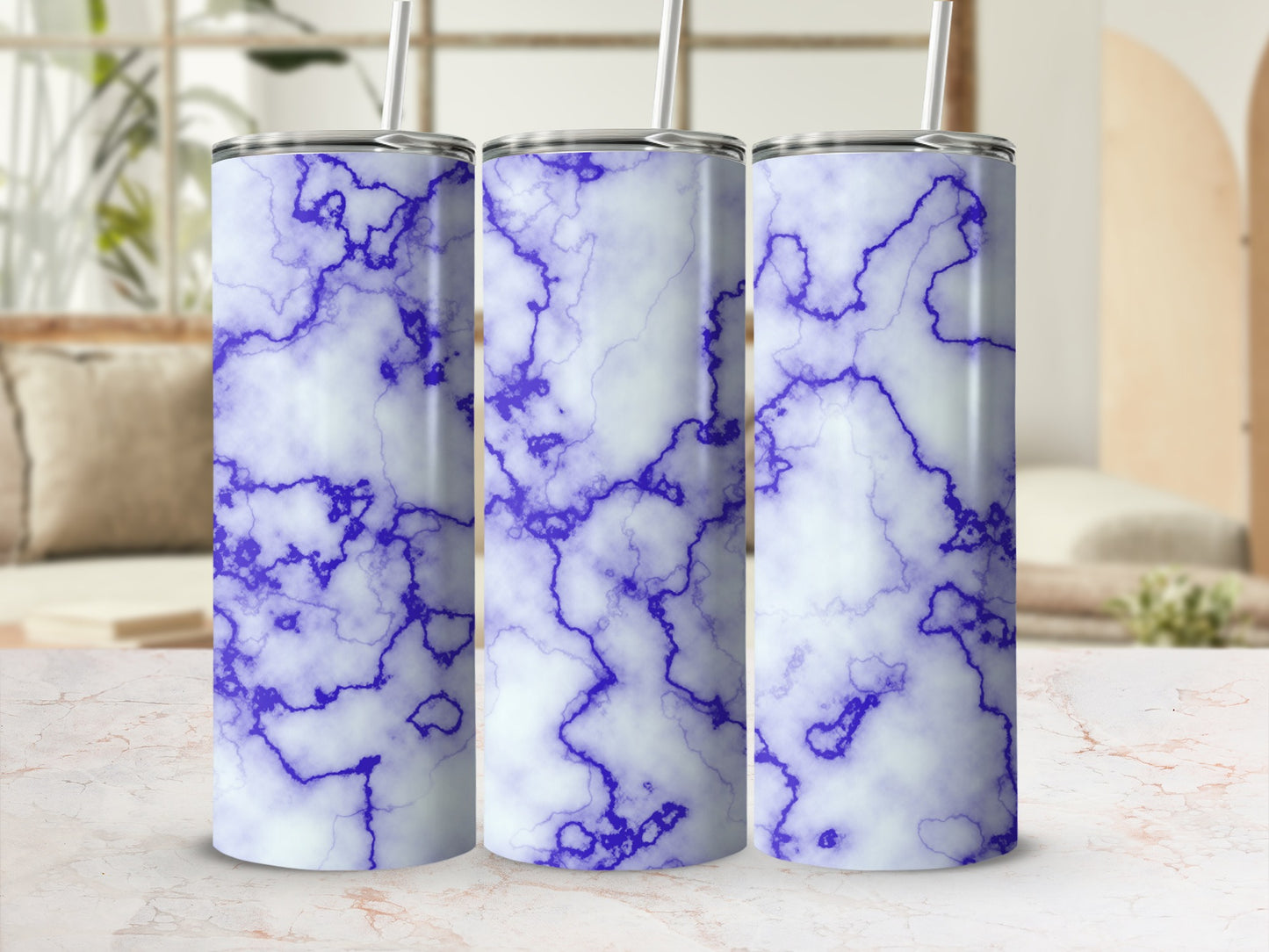 Three tall tumblers with a blue and white marble pattern and straws.