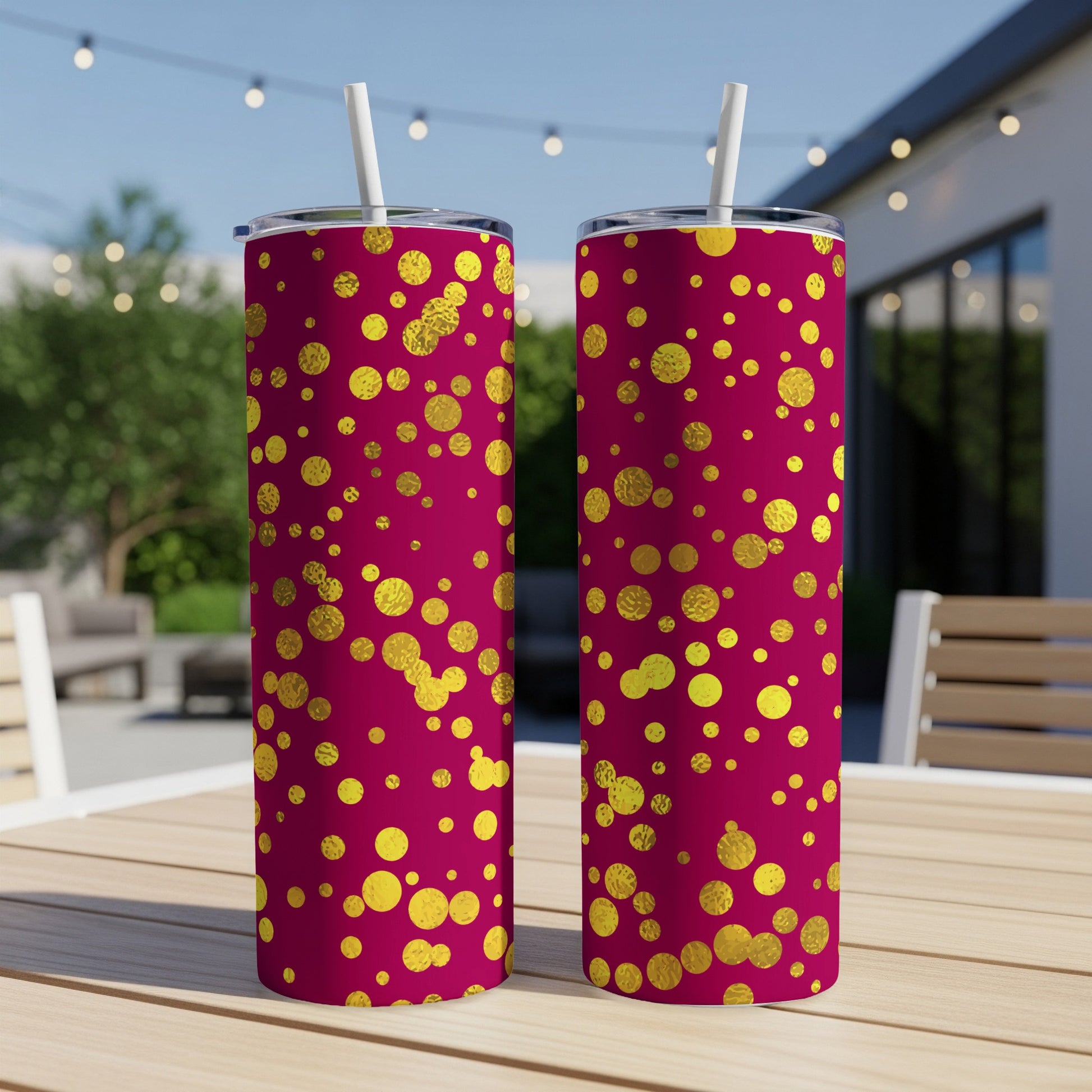 Two tumblers with magenta background and scattered gold circles, with straws.