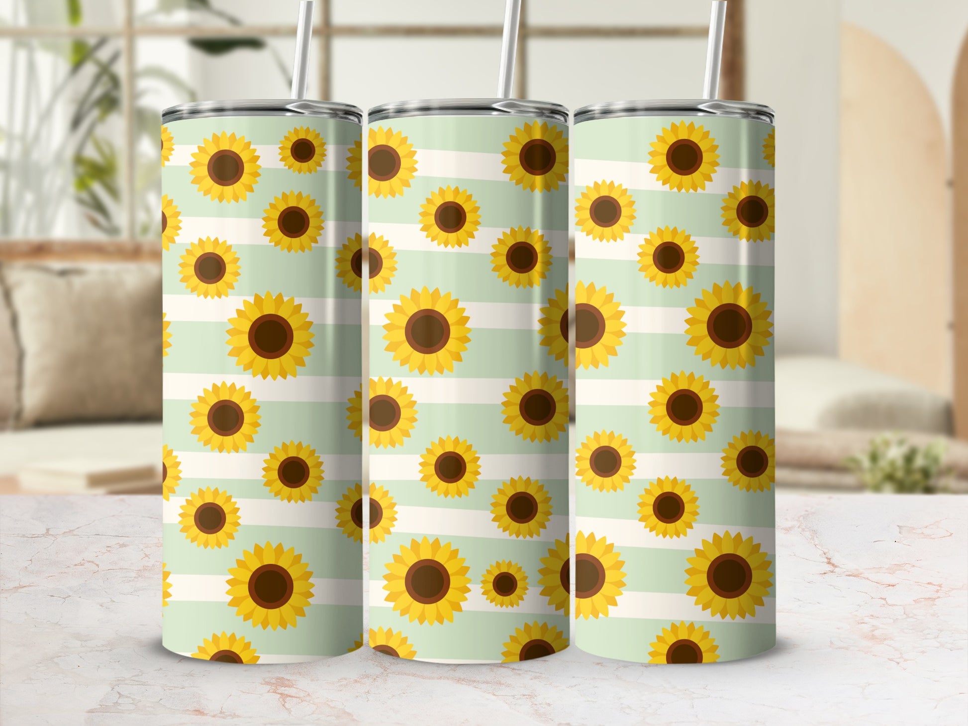 Three tumblers with a pattern of sunflowers on a mint green and white striped background.