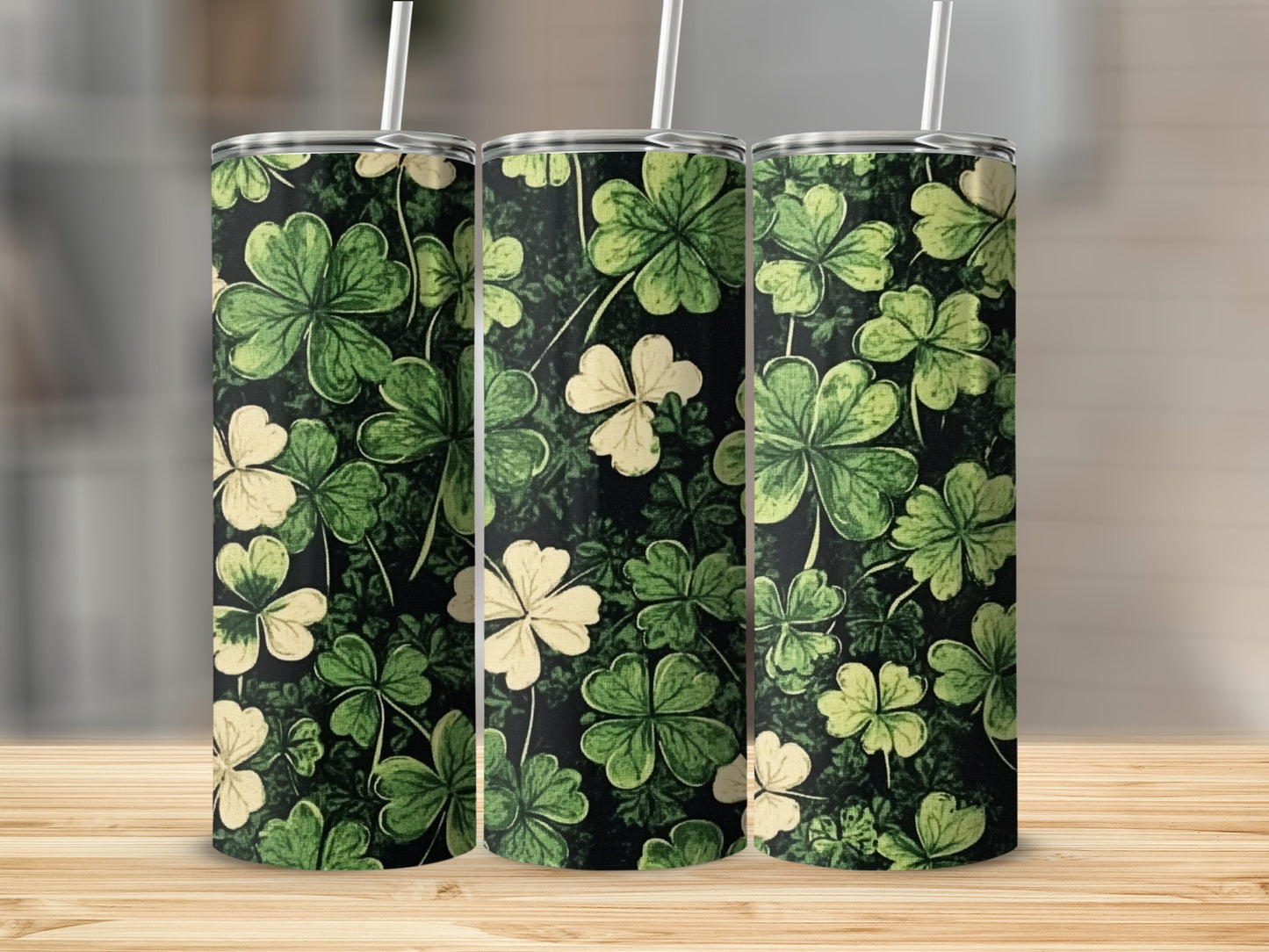 Three tumblers with a black background and green and white shamrock pattern.