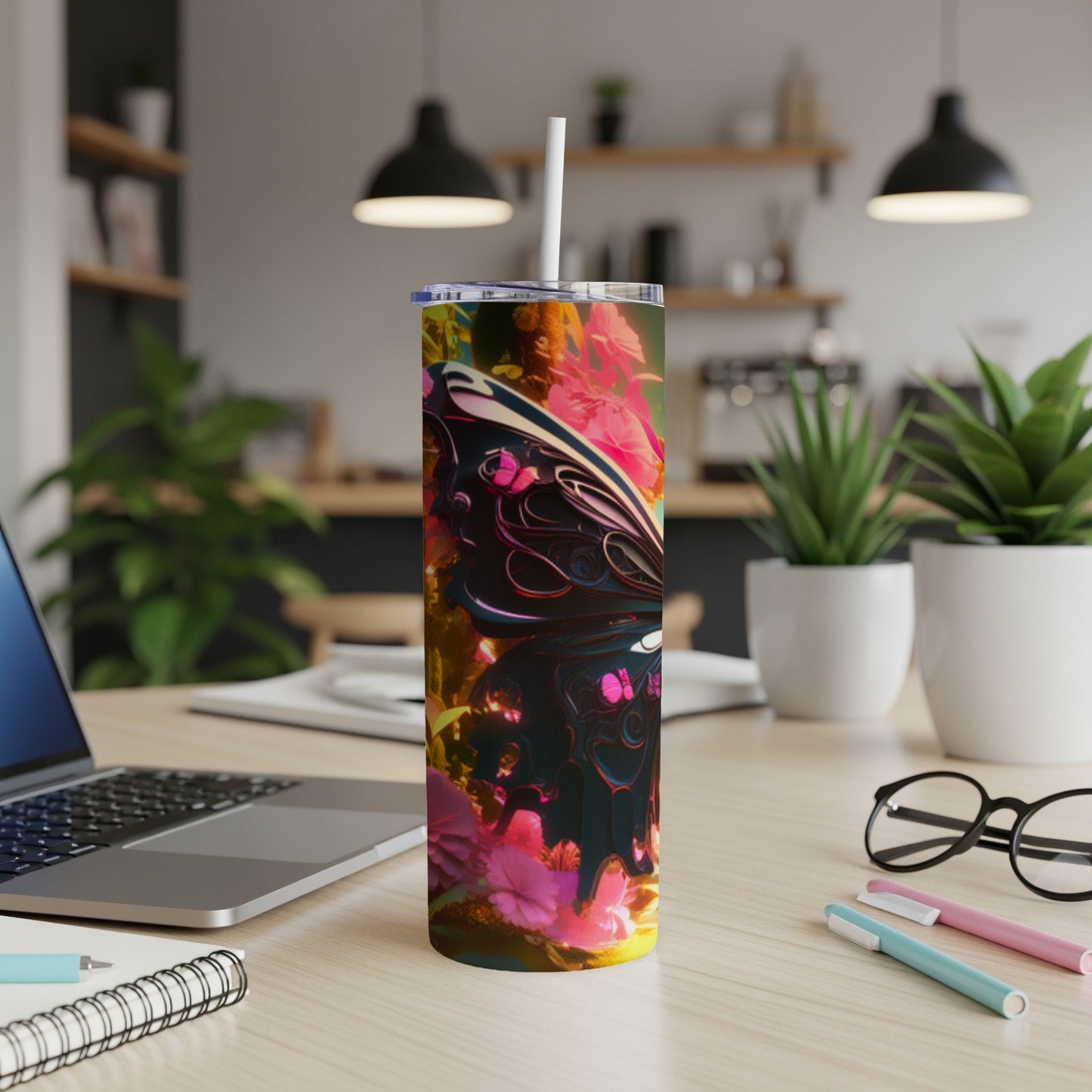 Tumbler with a colorful butterfly and floral design on a desk.