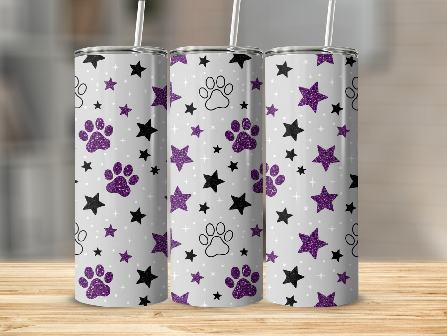Silver tumbler with purple paw prints and black stars pattern.
