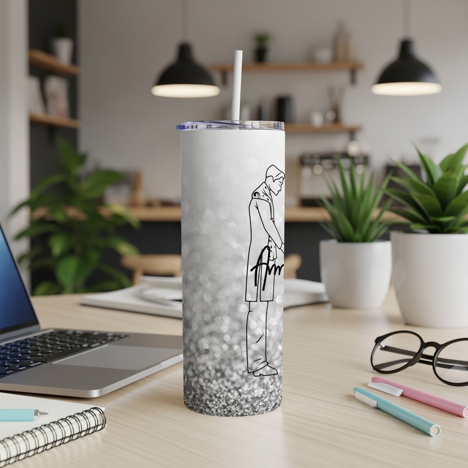 White tumbler with silver glitter and a line drawing of a person.