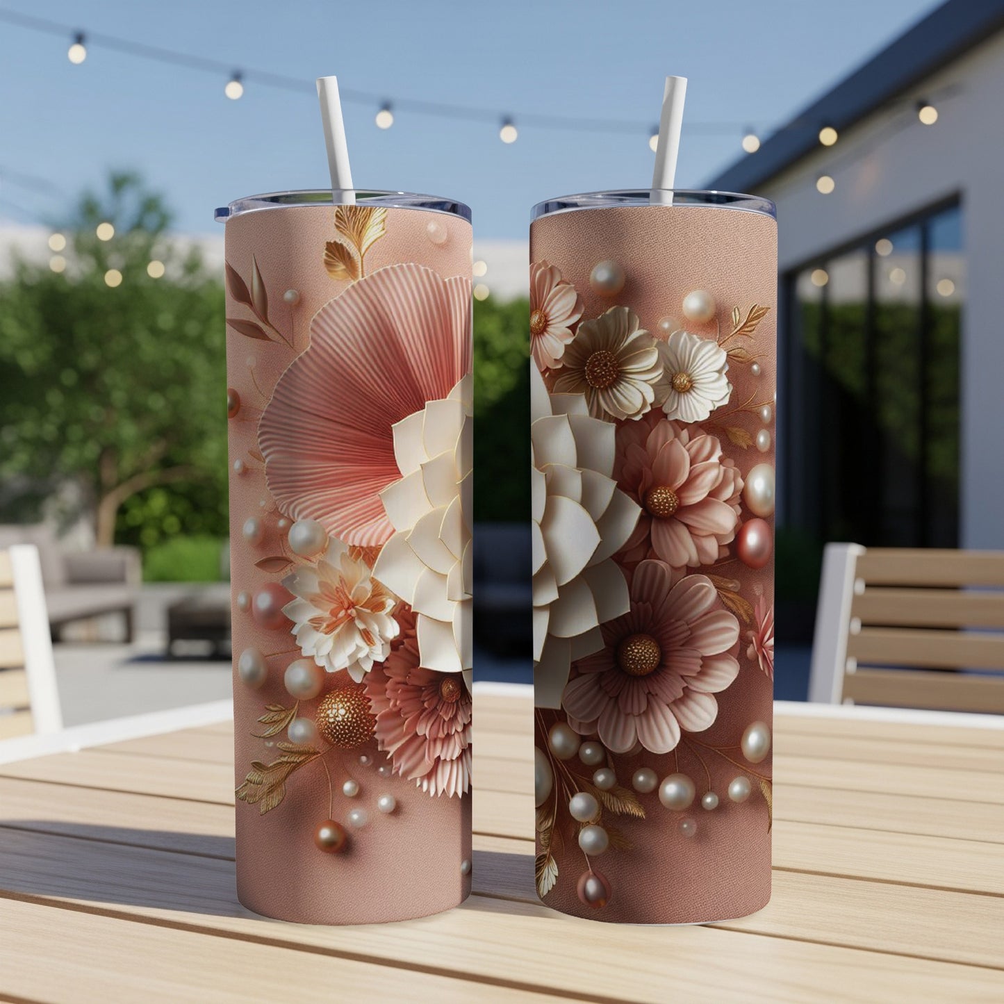 Two pink tumblers with floral and pearl accents on a wooden table.