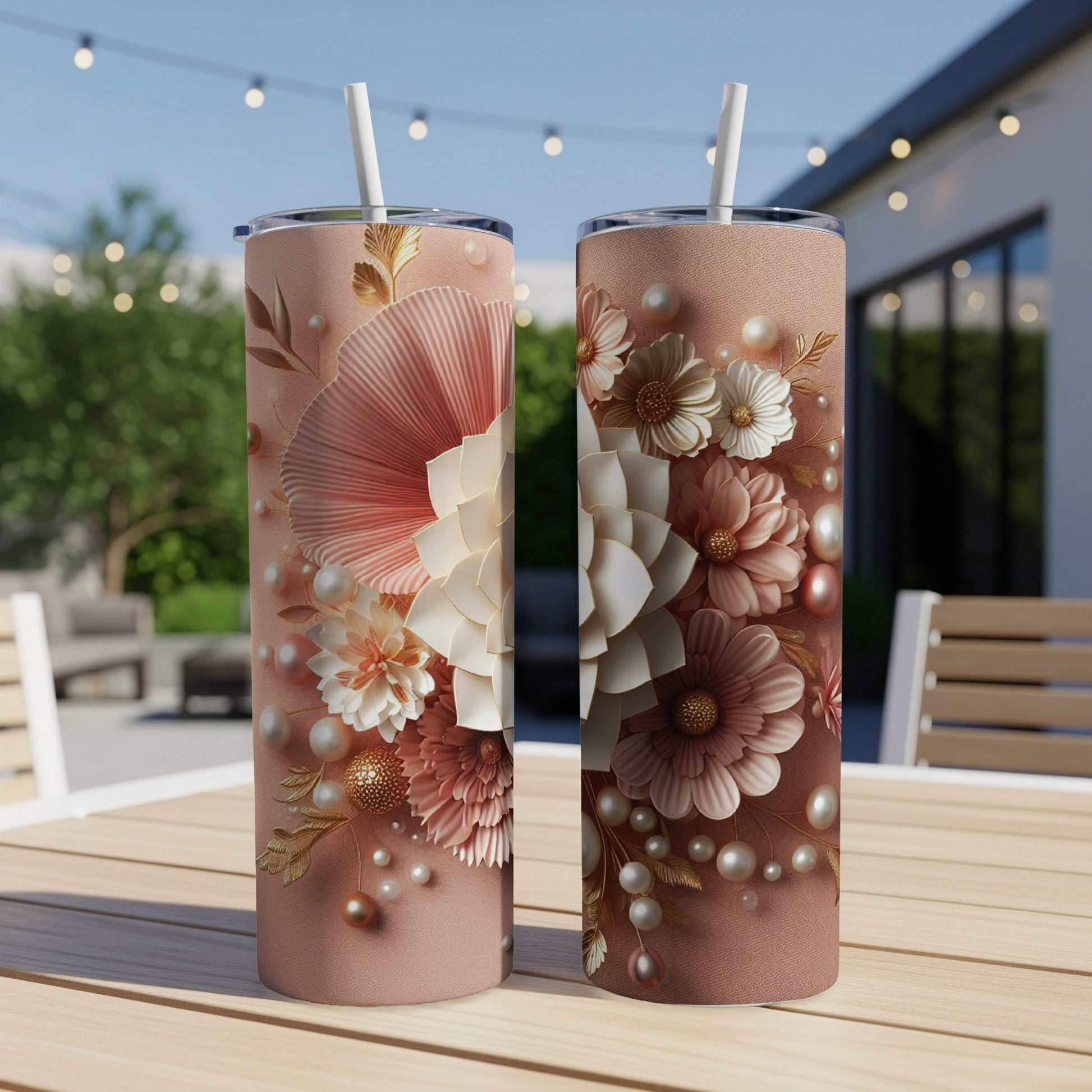 Two pink tumblers with floral and pearl accents on a wooden table.