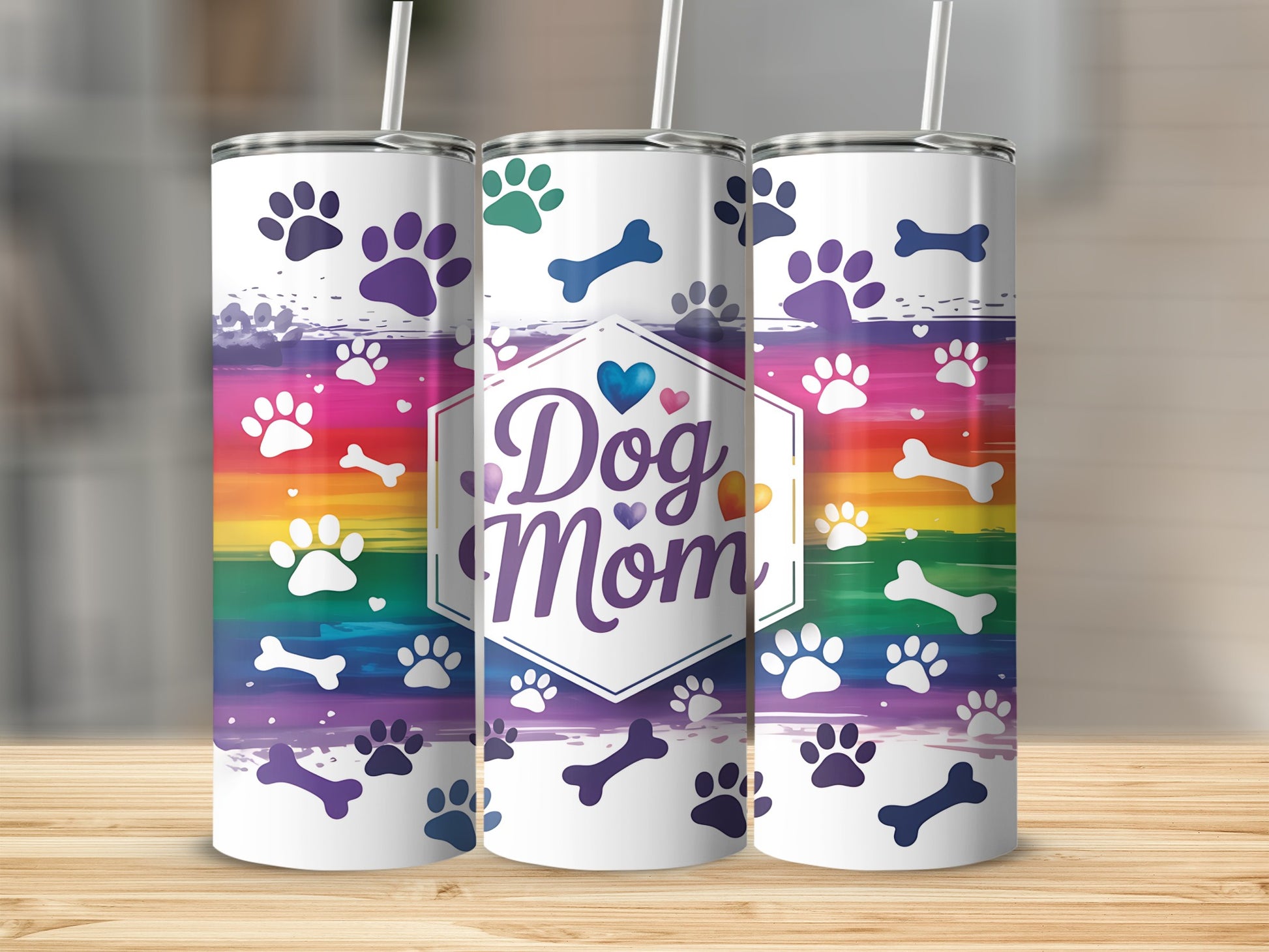 Dog Mom tumbler with rainbow paw prints and bone graphic.