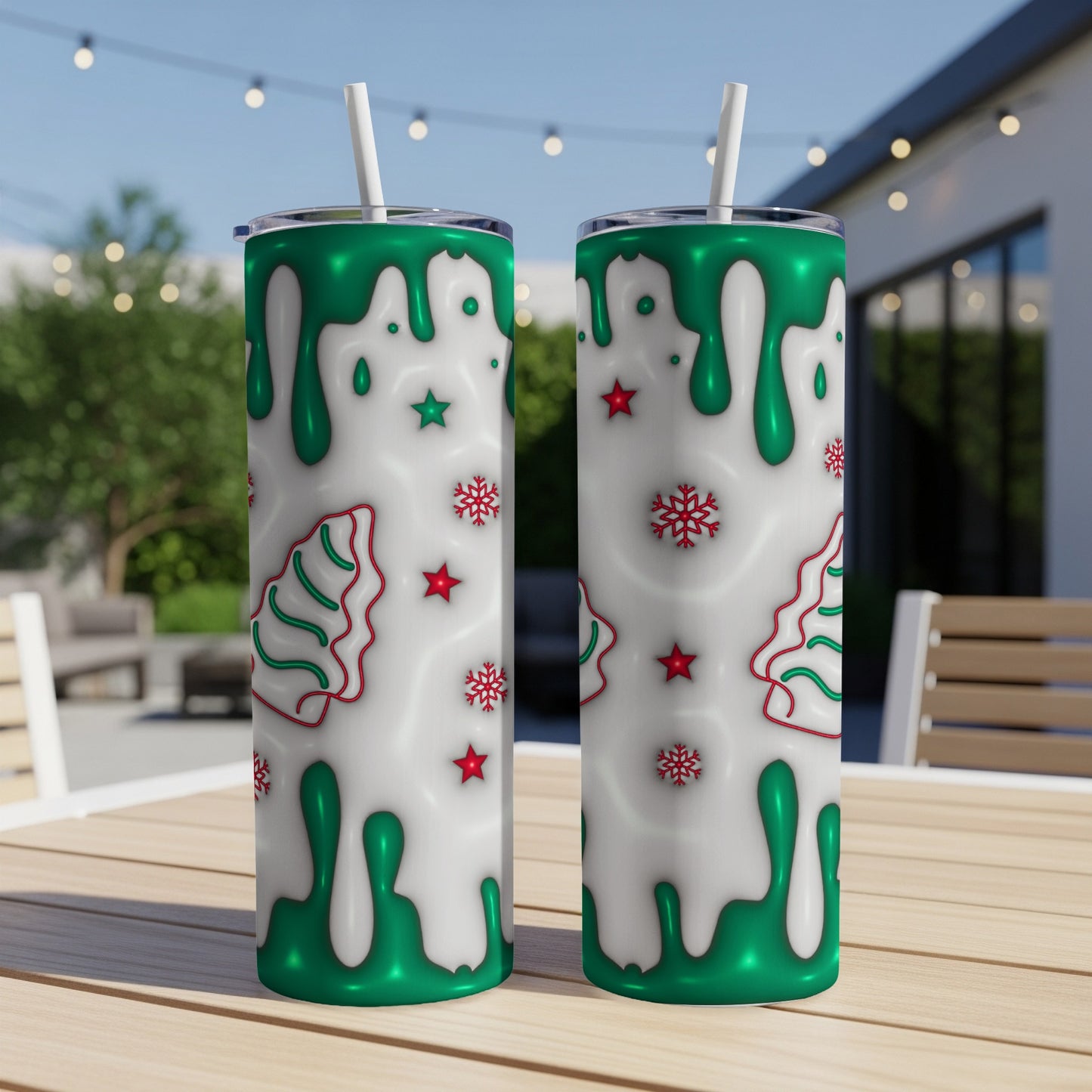 Two white tumblers with green drip and snowflake Christmas tree designs.