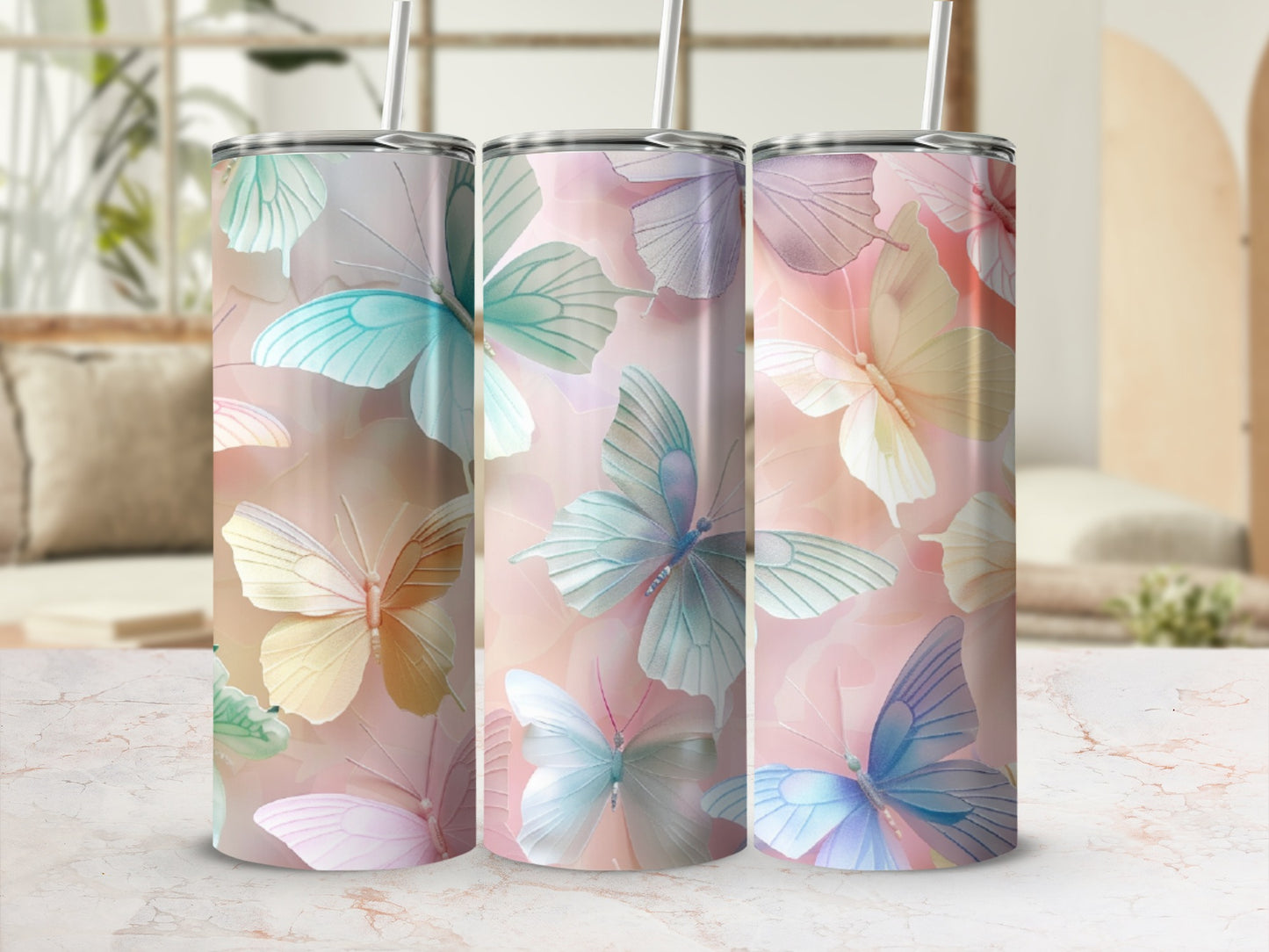 Three tumblers with watercolor butterfly designs in pastel colors.